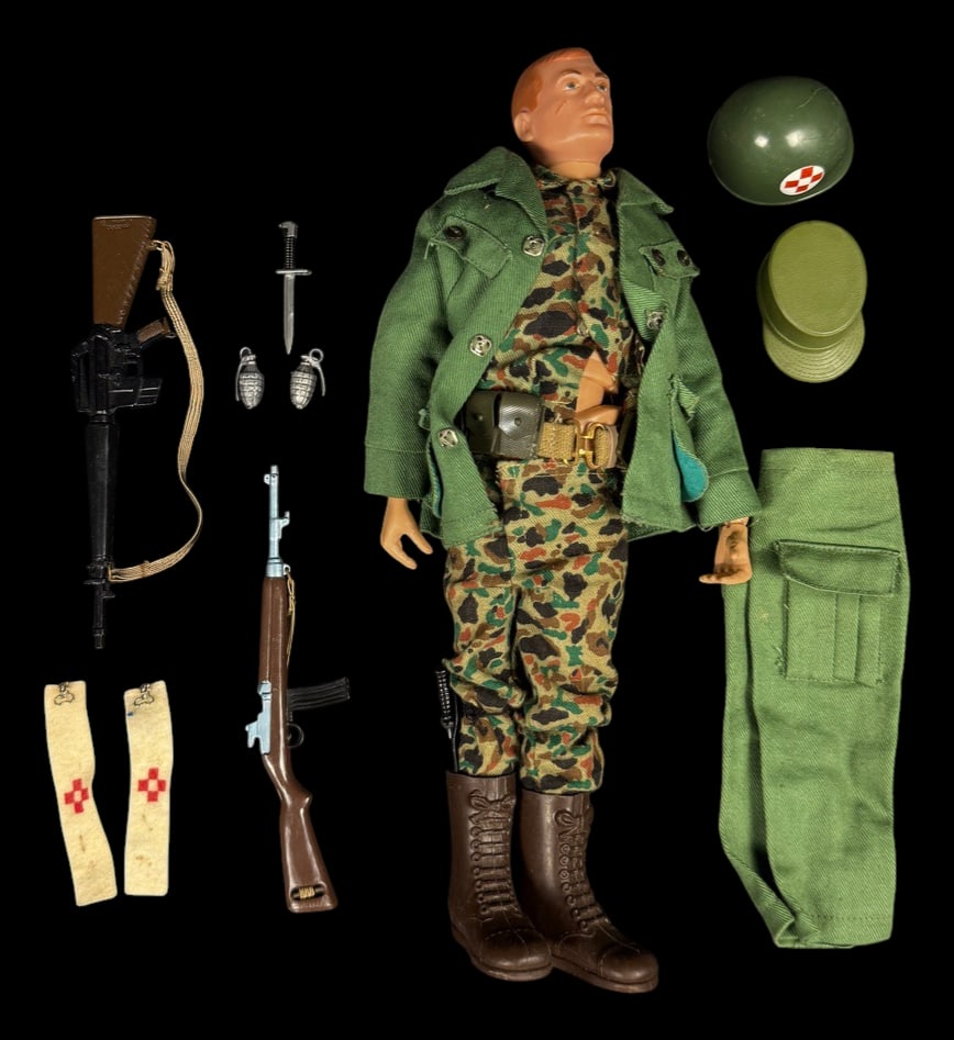 Vintage 1964 G.I. Joe Medic Figure: 1964 G.I. Joe medic figure wearing camouflage uniform and green field jacket with medic helmet, armband, rifle, carrying bag, and field accessories.