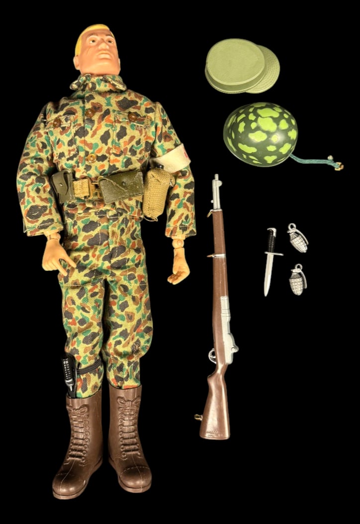 Vintage 1964 G.I. Joe Camouflage Action Soldier: 1964 G.I. Joe Action Soldier in camouflage uniform with M1 rifle, camouflage helmet, canteen, grenades, fighting knife, and field gear.