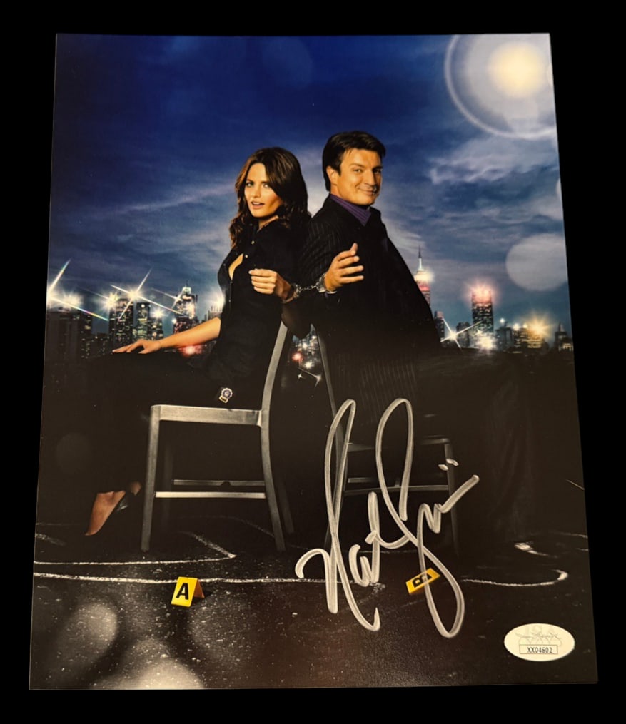 Nathan Fillion Signed Castle Photograph with COA: Signed photograph from Castle signed by Nathan Fillion with JSA COA.