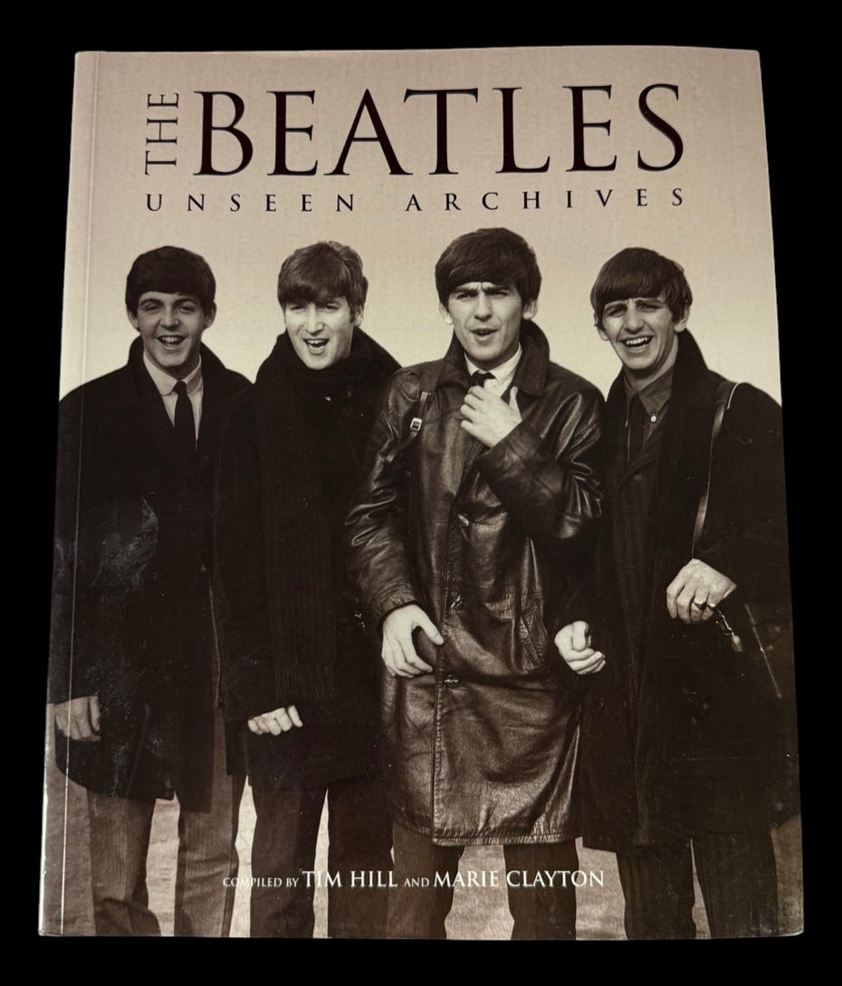 The Beatles: Unseen Archives: Illustrated hardcover The Beatles: Unseen Archives by Tim Hill and Marie Clayton, featuring rare photographs and historical commentary.