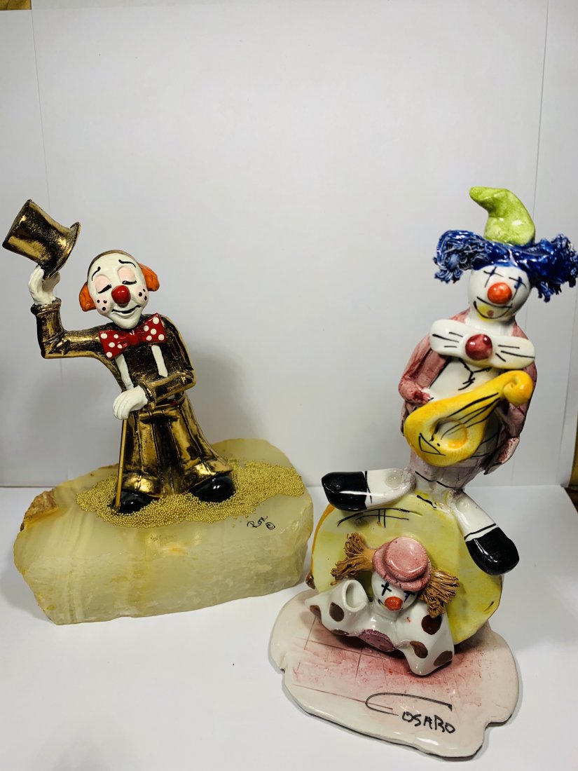 Signed Ron Lee Cast-iron clown and Cosaro Clown: Both clowns are 6 inches tall, Signed Porcelain casaro and signed ron lee Cast iron and painted gold clown