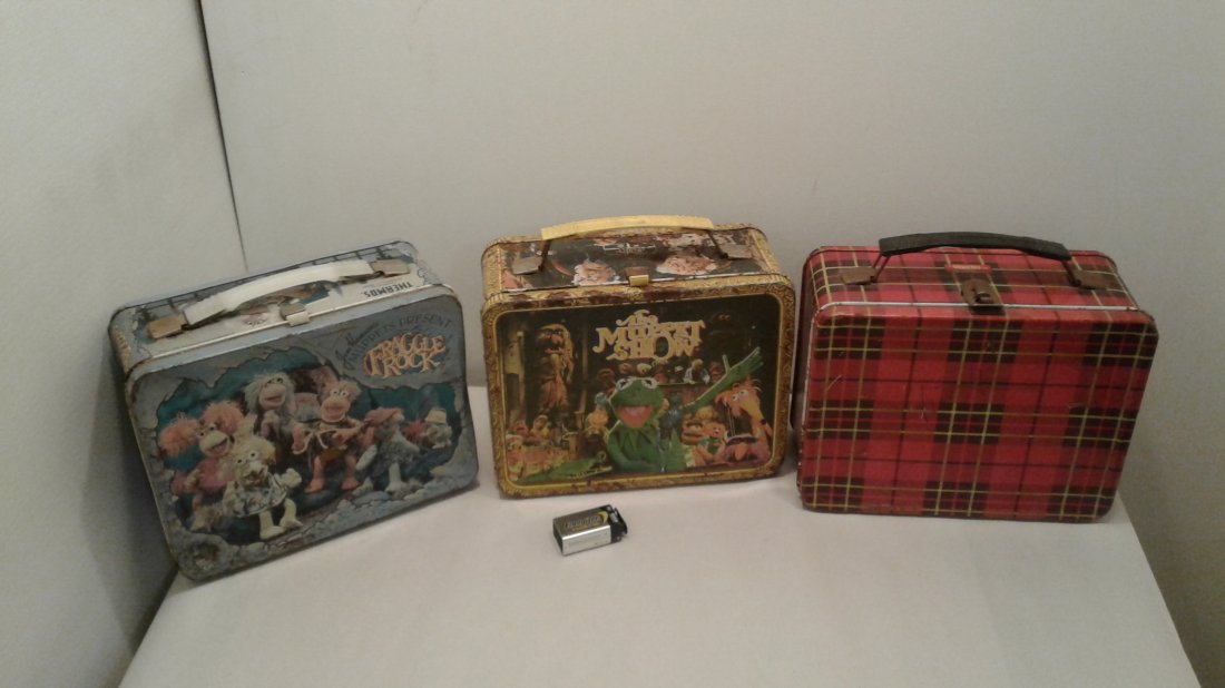 (3) Thermos Brand Lunch Boxes: Plaid/The Muppet Show/Fraggle Rock. Plaid box has matching thermos. Fraggle Rock lunch box has ;broken hinges. The Muppet Show has some rust. See pictures for condition. As is.