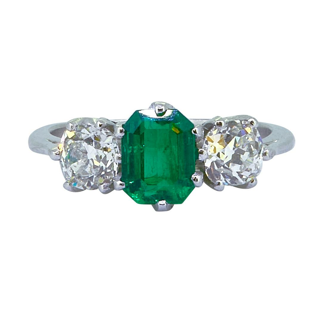 EMERALD AND DIAMOND 3-STONE RING: EMERALD AND DIAMOND 3-STONE RING, set with a central emerald of approx. 0.90 ct. Flanked with a diamond on each side totalling approx. 0.30 ct. Size M. 3.8 grams.