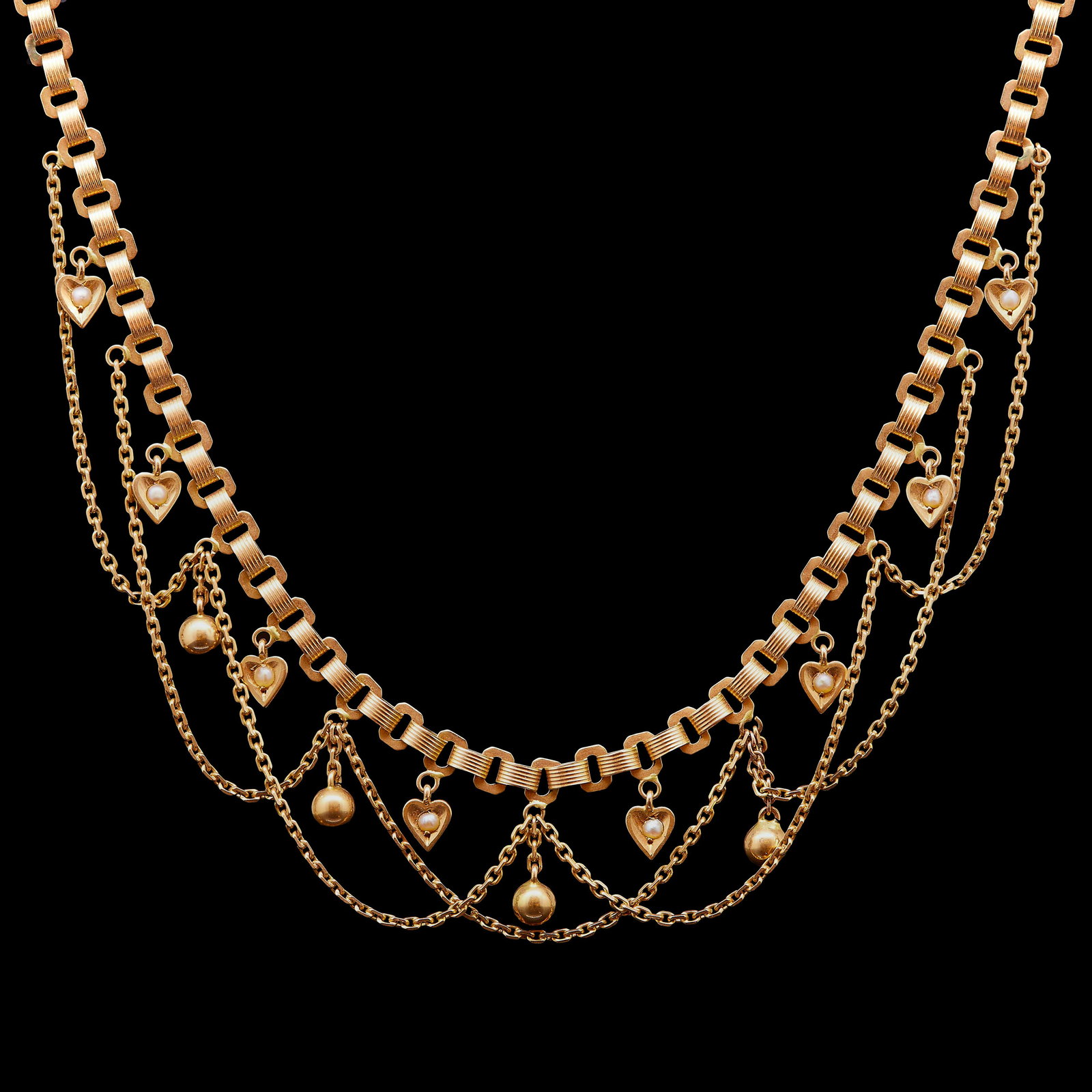 ANTIQUE VICTORIAN PEARL DROP NECKLACE: ANTIQUE VICTORIAN PEARL DROP NECKLACE, the link neklace with garland drop to the bottom section, alternated with pearl set heart drops, and ball drops. L. 38 cm. 11.7 grams.