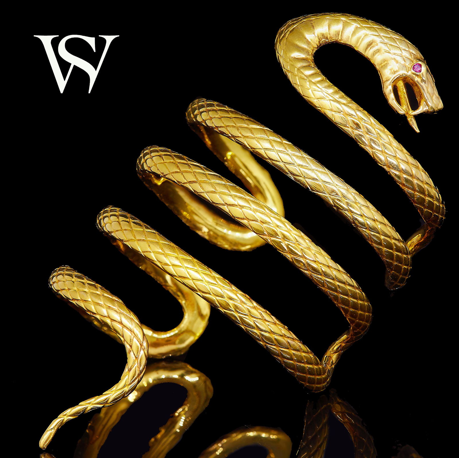 STEPHEN WEBSTER Attrib., SNAKE BANGLE: STEPHEN WEBSTER Attrib., SNAKE BANGLE, designed as a snake in 4 loops. The eye set with a red stone. Inner diam. 5 cm. 94.5 grams. Unmarked, The vendor purchased this bangle as a special commission fr