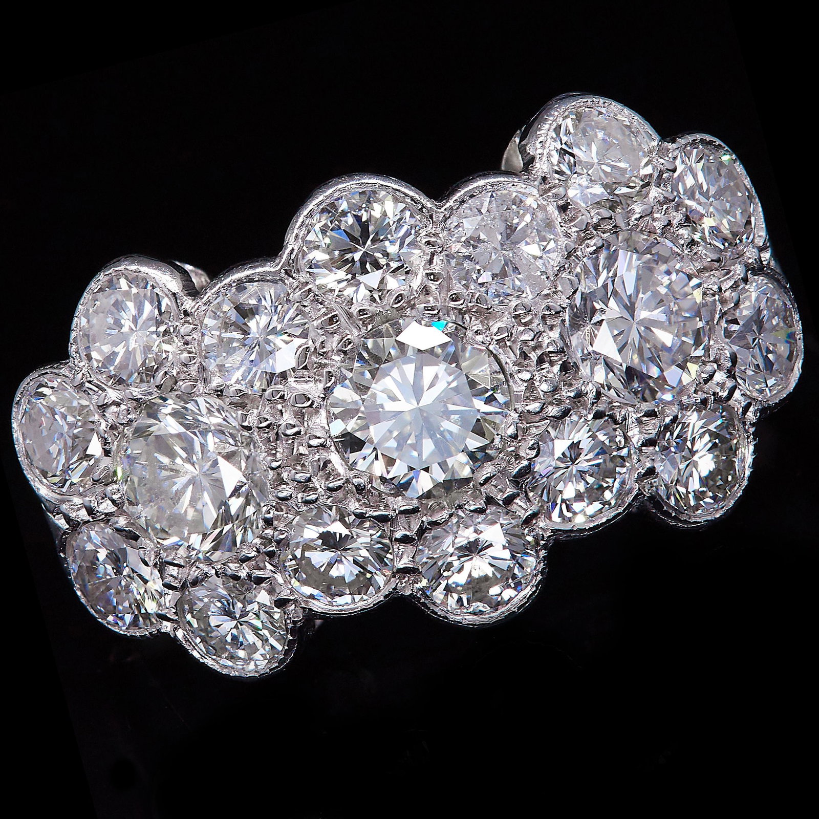 DIAMOND TRIPLE CLUSTER DRESS RING: DIAMOND TRIPLE CLUSTER DRESS RING, designed as 3 interlinking clusters, set with diamonds totalling approx. 2.35 ct. Size M. 3.7 grams.
