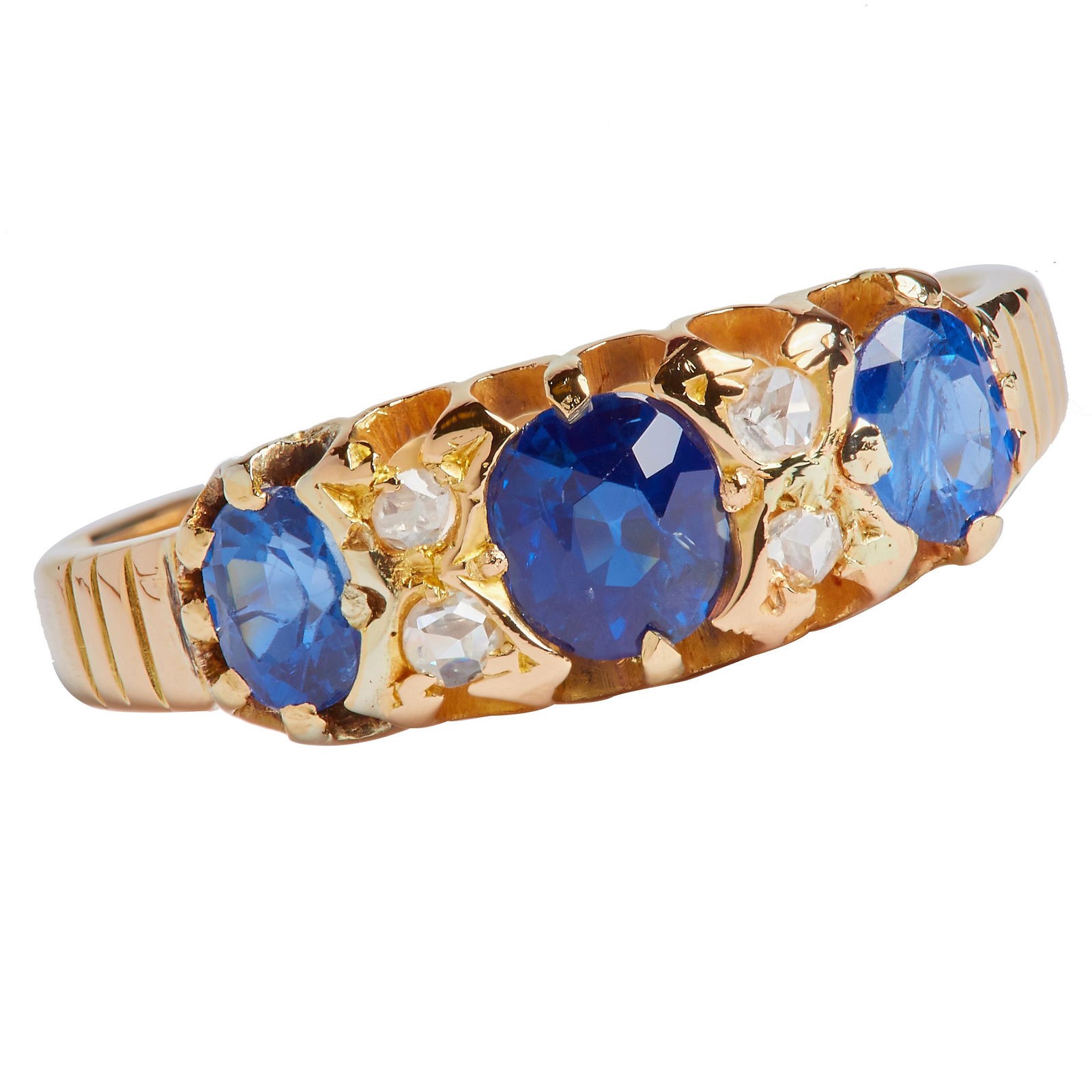 SAPPHIRE AND DIAMOND RING: SAPPHIRE AND DIAMOND RING, in 18 ct. gold. Set with 3 blue sapphires totalling approx. 0.90 ct. Flanked with 4 diamonds. Size K 1/2. 2.5 grams.
