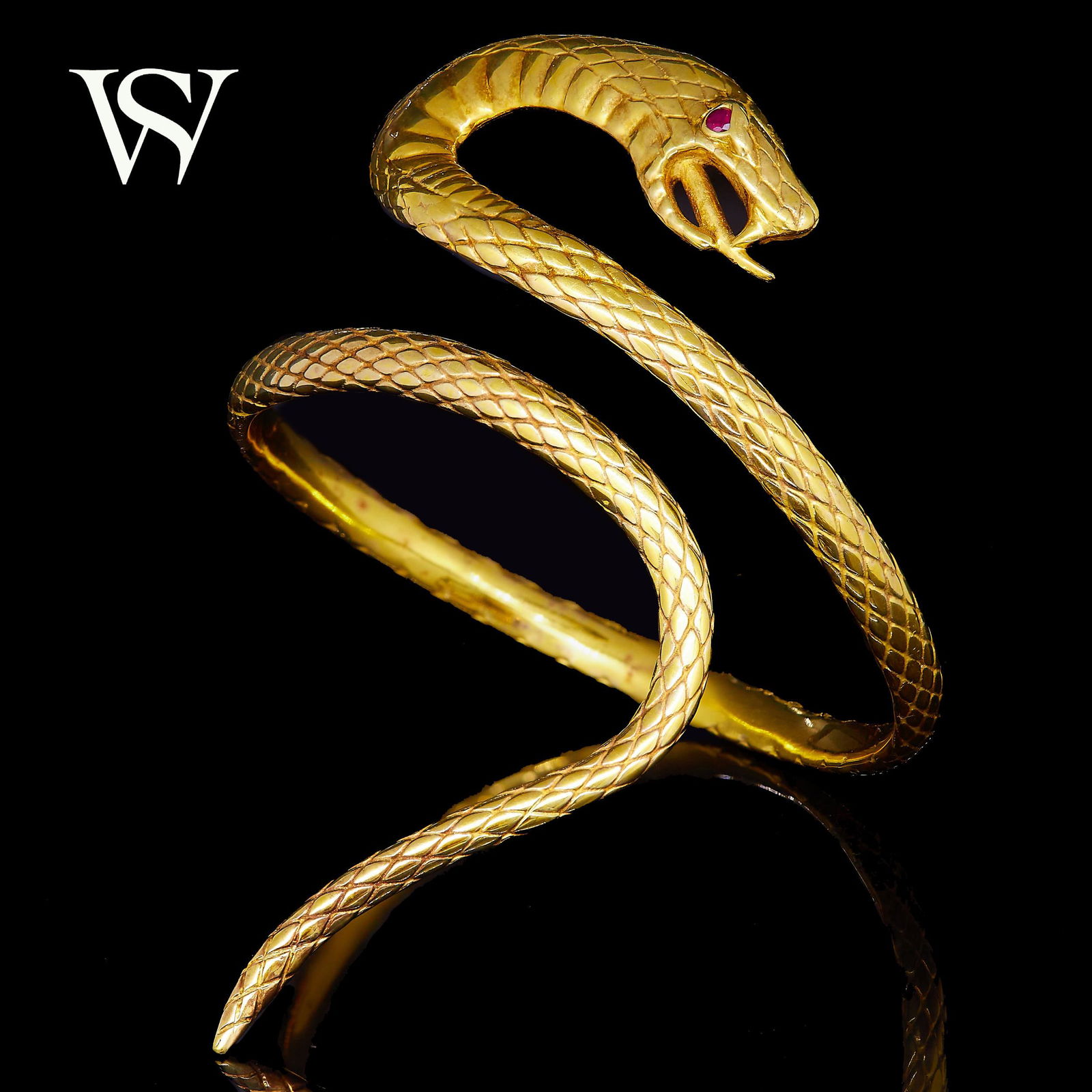 STEPHEN WEBSTER Attrib., SNAKE BANGLE: STEPHEN WEBSTER Attrib., SNAKE BANGLE, designed as a coiled snake. The eye set with a red stone. Inner diam. 7 cm. 55.4 grams. Unmarked, The vendor purchased this bangle as a special commission from S
