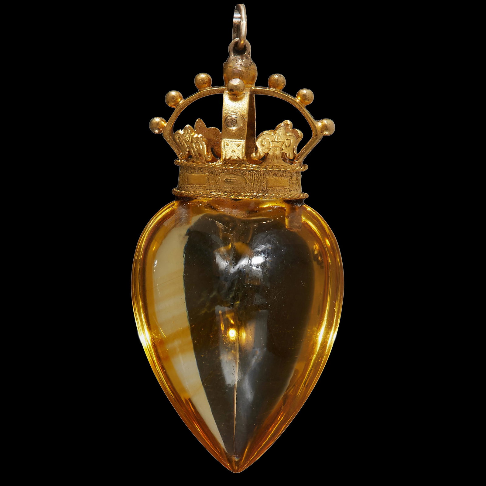 NO RESERVE, CROWNED CITRINE HEART PENDANT: NO RESERVE, CROWNED CITRINE HEART PENDANT, the citrine carved in the shape of a heart, topped with a crown. L. 3.7 cm. 7.3 grams.