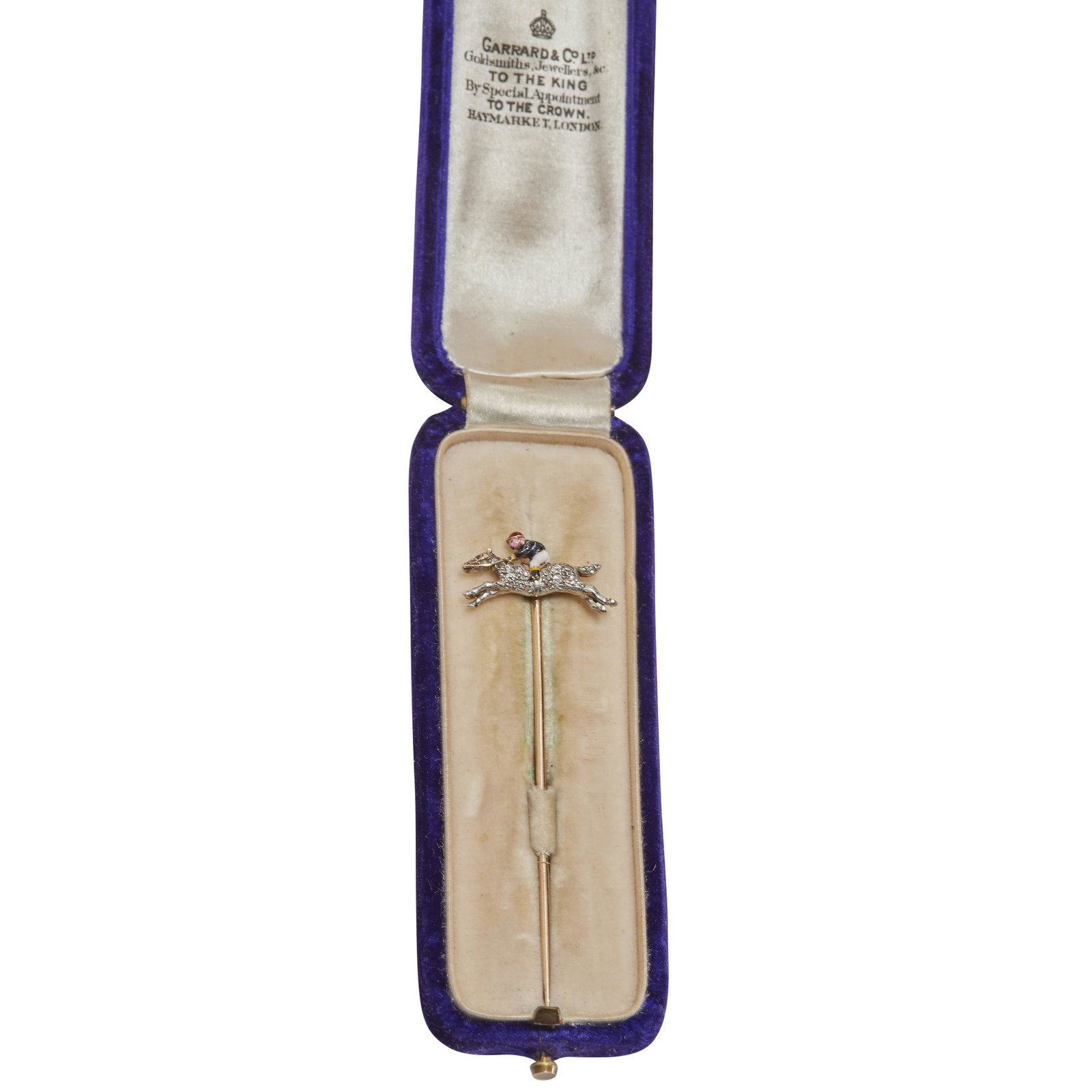 NO RESERVE, EDWARDIAN DIAMOND AND ENAMEL JOCKEY STICK PIN: NO RESERVE, EDWARDIAN DIAMOND AND ENAMEL JOCKEY STICK PIN, The horse set with diamonds, the jockey decorated with enamel. L. 2 cm. 3.3 grams. With box.
