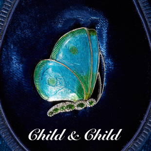 CHILD AND CHILD, ENAMEL AND PERIDOT BUTTERFLY BROOCH: CHILD AND CHILD, ENAMEL AND PERIDOT BUTTERFLY BROOCH. The wings of the butterfly decorated with blue and green enamel. The body set with 6 peridot. Makers mark for Child and Child. L. 2.5 cm. 9 grams.