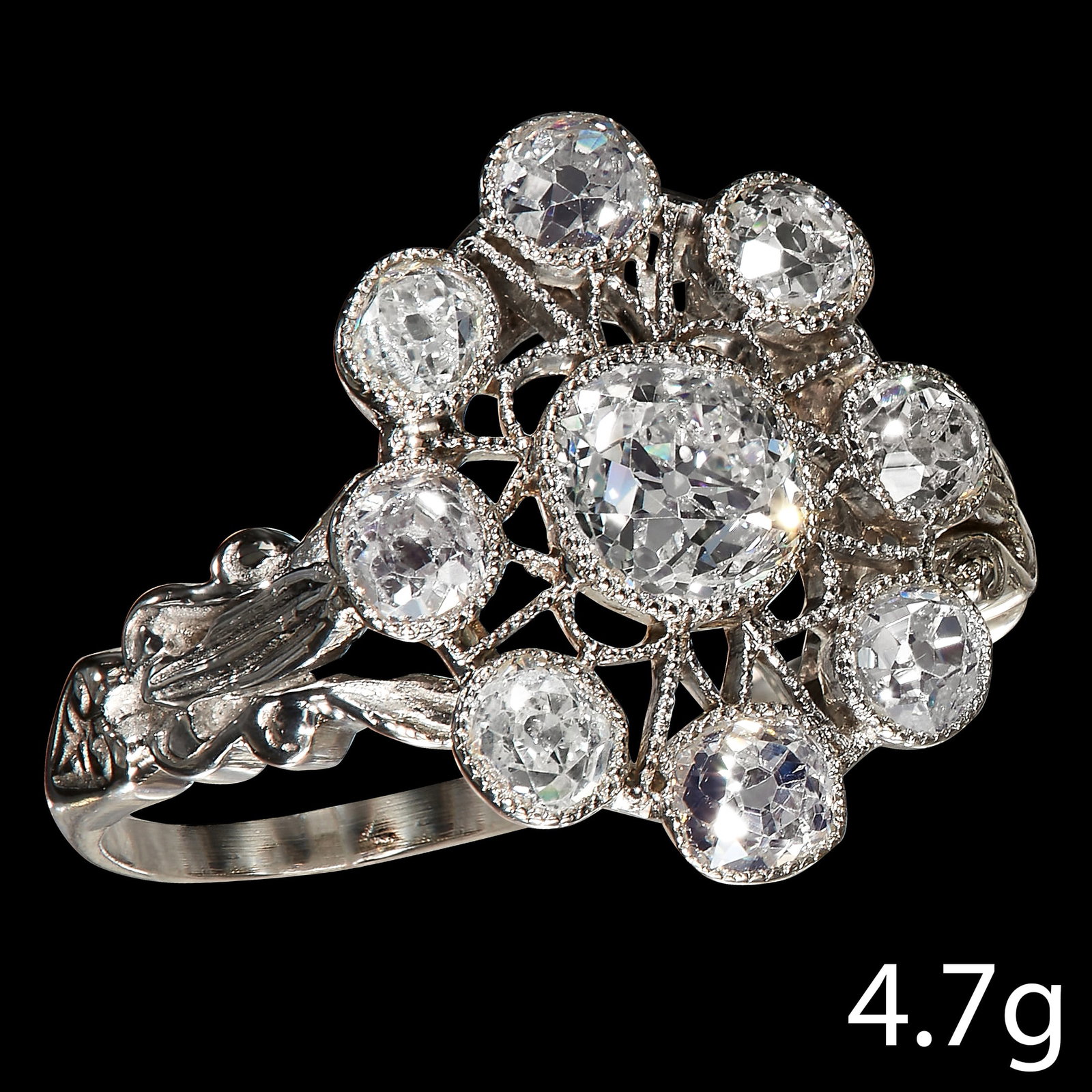 DIAMOND CLUSTER RING: DIAMOND CLUSTER RING, in 18 ct. gold. Set with bright and lively old cut diamonds, totalling approx. 1.45 ct. Size O. 4.7 grams.