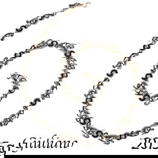CARLO GIULIANO, STUNNING ENAMEL AND DIAMOND NECKLACE: CARLO GIULIANO, STUNNING ENAMEL AND DIAMOND NECKLACE,High carat gold.The links of scrolling wing design, decorated with black and white ename.each link alternated with a round enameled and diamond set