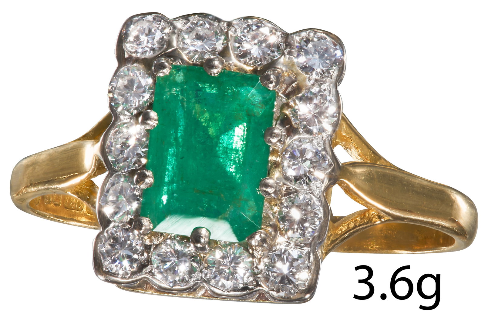 EMERALD AND DIAMOND CLUSTER RING.: EMERALD AND DIAMOND CLUSTER RING. 18 ct. gold.Vibrant emerald of approx. 1.03 ct.Diamonds bright and lively.Size Q.3.6 grams.