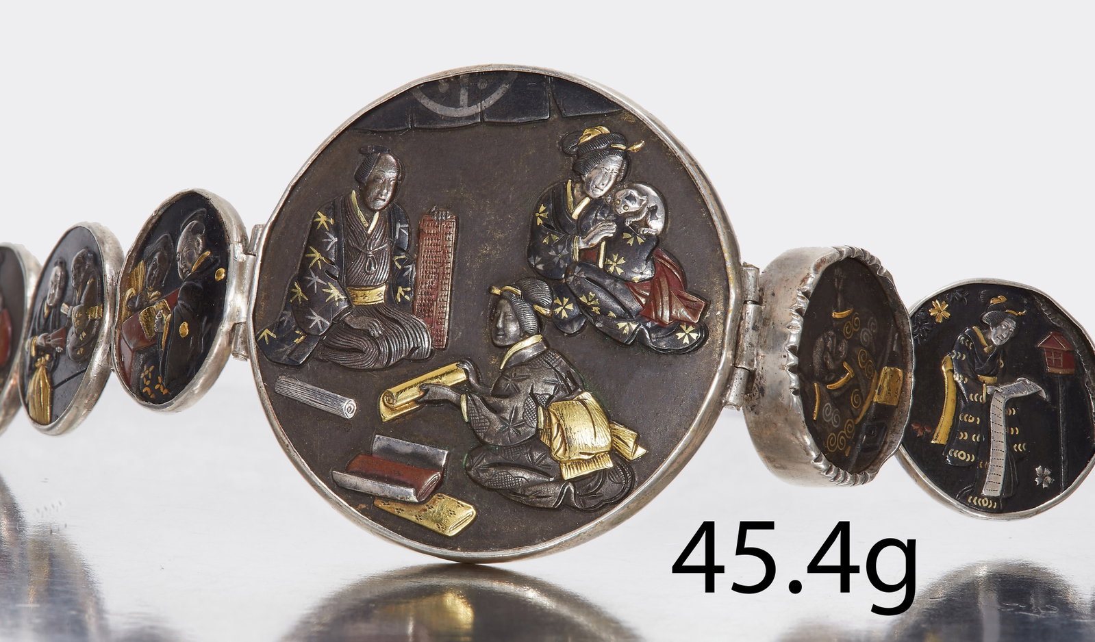 LATE 19TH CENTURY SILVER MOUNTED SHAKUDO BRACELET.: LATE 19TH CENTURY SILVER MOUNTED SHAKUDO BRACELET. Set with seven panels depicting Japanese scenery. L 15 cm. 45.4 grams.