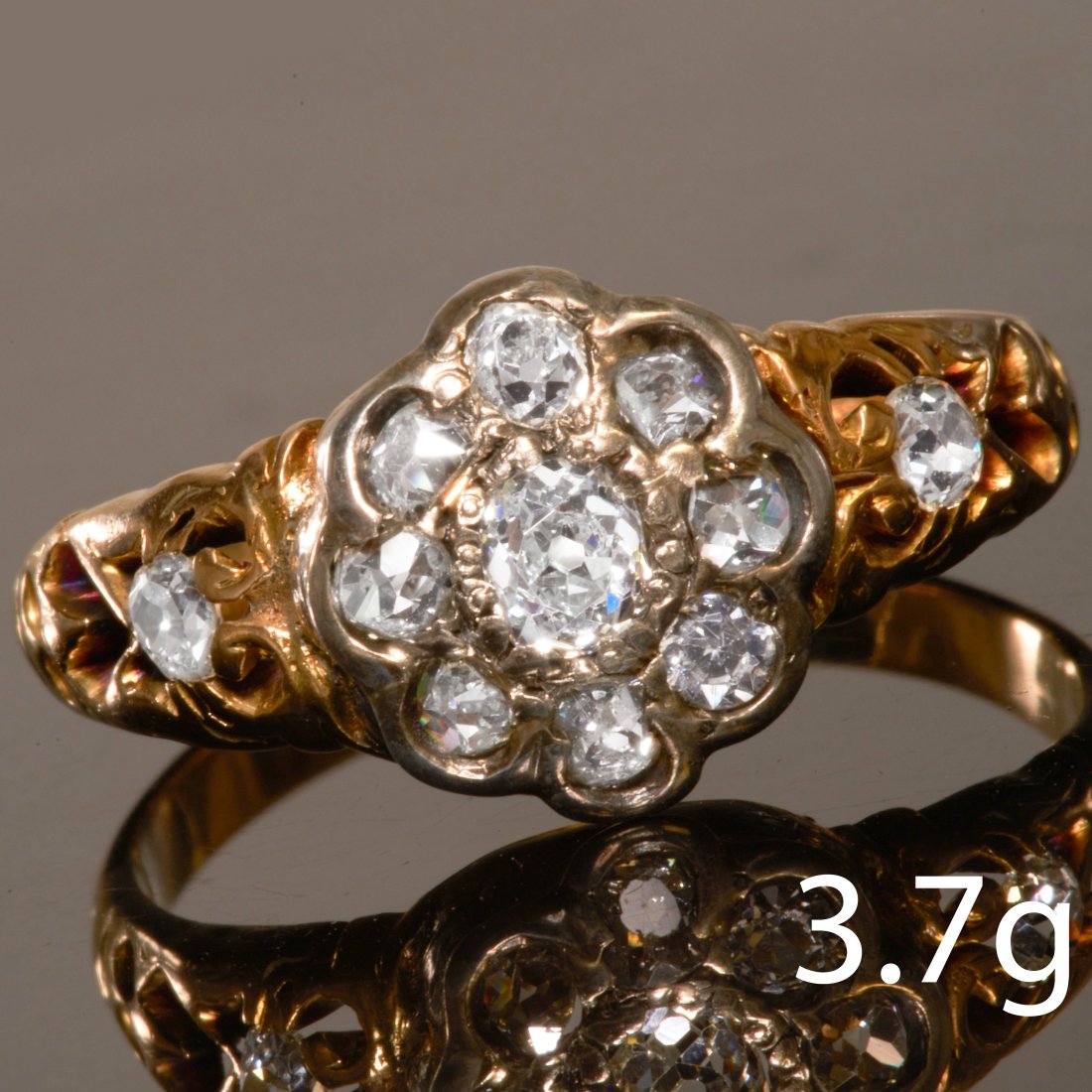DIAMOND CLUSTER RING: DIAMOND CLUSTER RING,High carat gold.Diamonds bright and lively, and a diamond on each shoulder.Size Q 1/2.3.7 grams.