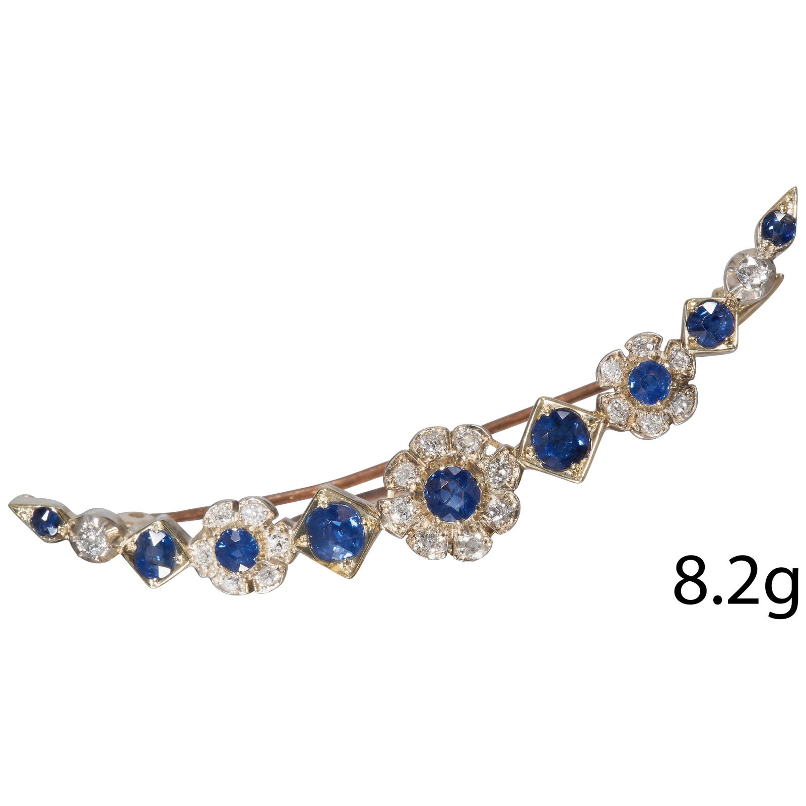 EDWARDIAN SAPPHIRE AND DIAMOND CRESCENT BROOCH: EDWARDIAN SAPPHIRE AND DIAMOND CRESCENT BROOCH,15 ct. gold and silver.Blue sapphires totalling approx. 1.86 ct.Diamonds bright and lively.W. 6.6 cm.8.2 grams.Blue sapphires vibrant and well matched