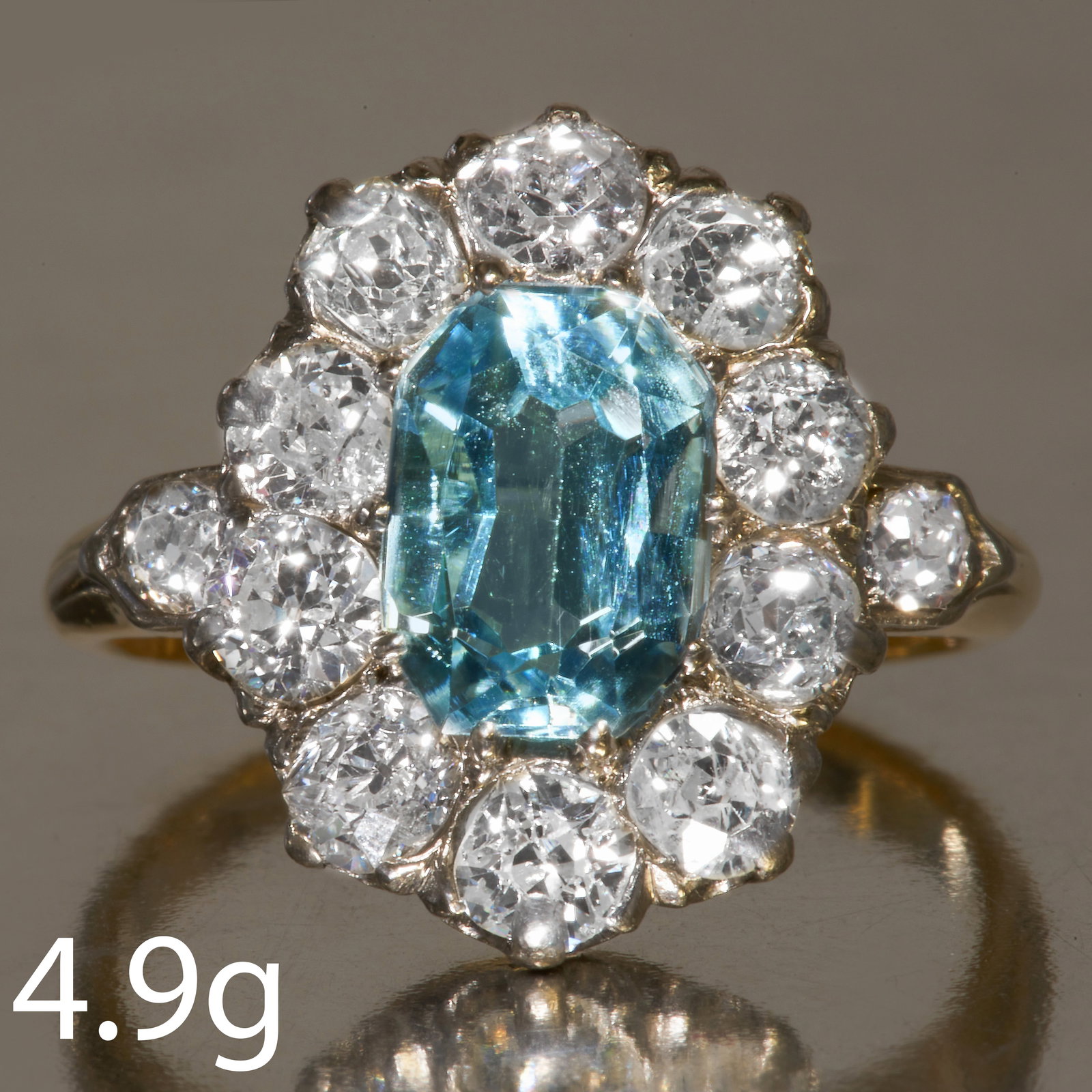 AQUAMARINE AND DIAMOND CLUSTER RING: AQUAMARINE AND DIAMOND CLUSTER RING,Vibrant aquamarine of approx. 1.55 ct.Diamonds bright and lively.Size L 1/2.4.9 grams.