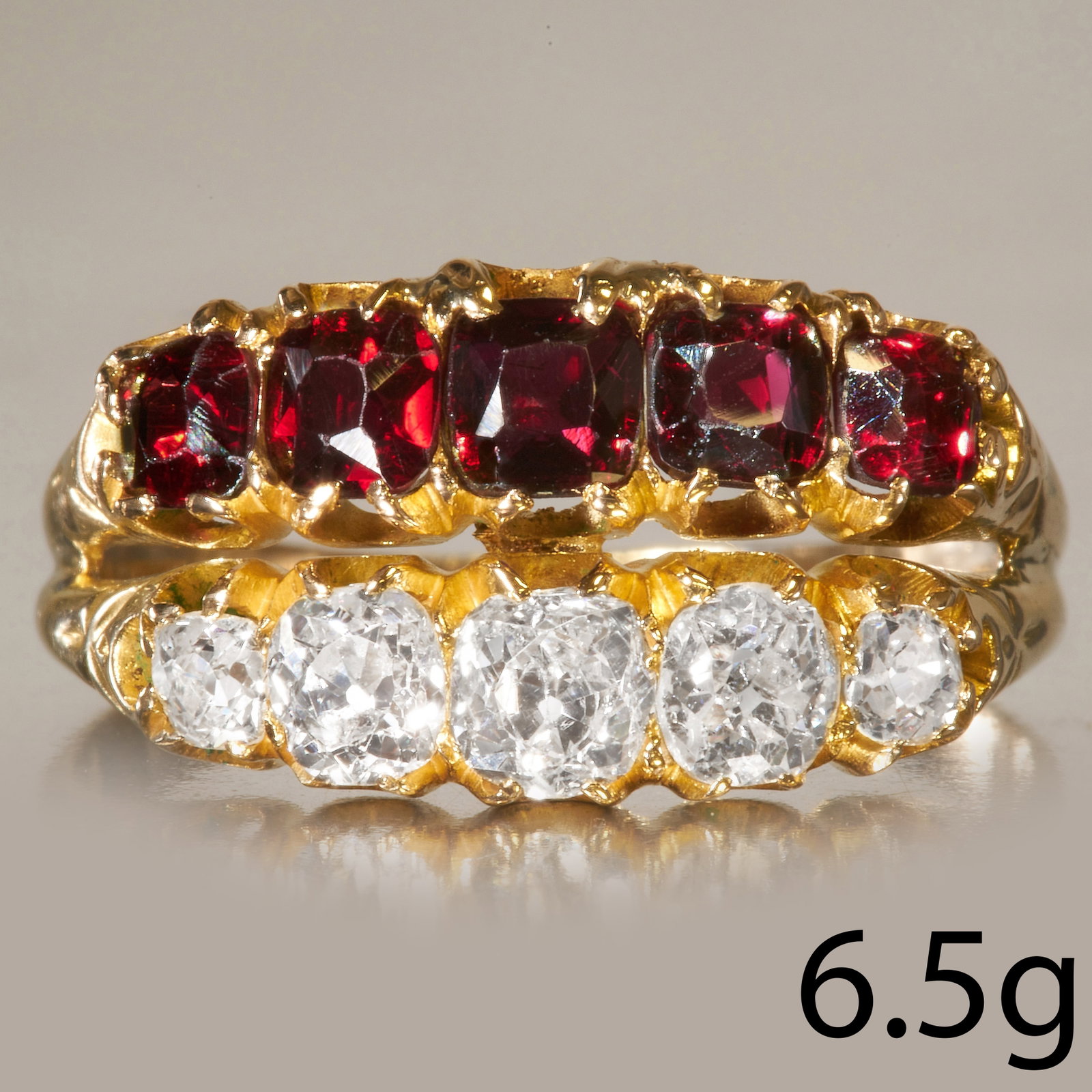 2-ROW DIAMOND AND GARNET RING: 2-ROW DIAMOND AND GARNET RING,High carat gold.Diamonds bright and lively, totalling approx. 0.85 ct.Rich coloured garnets.Size R.6.5 grams.