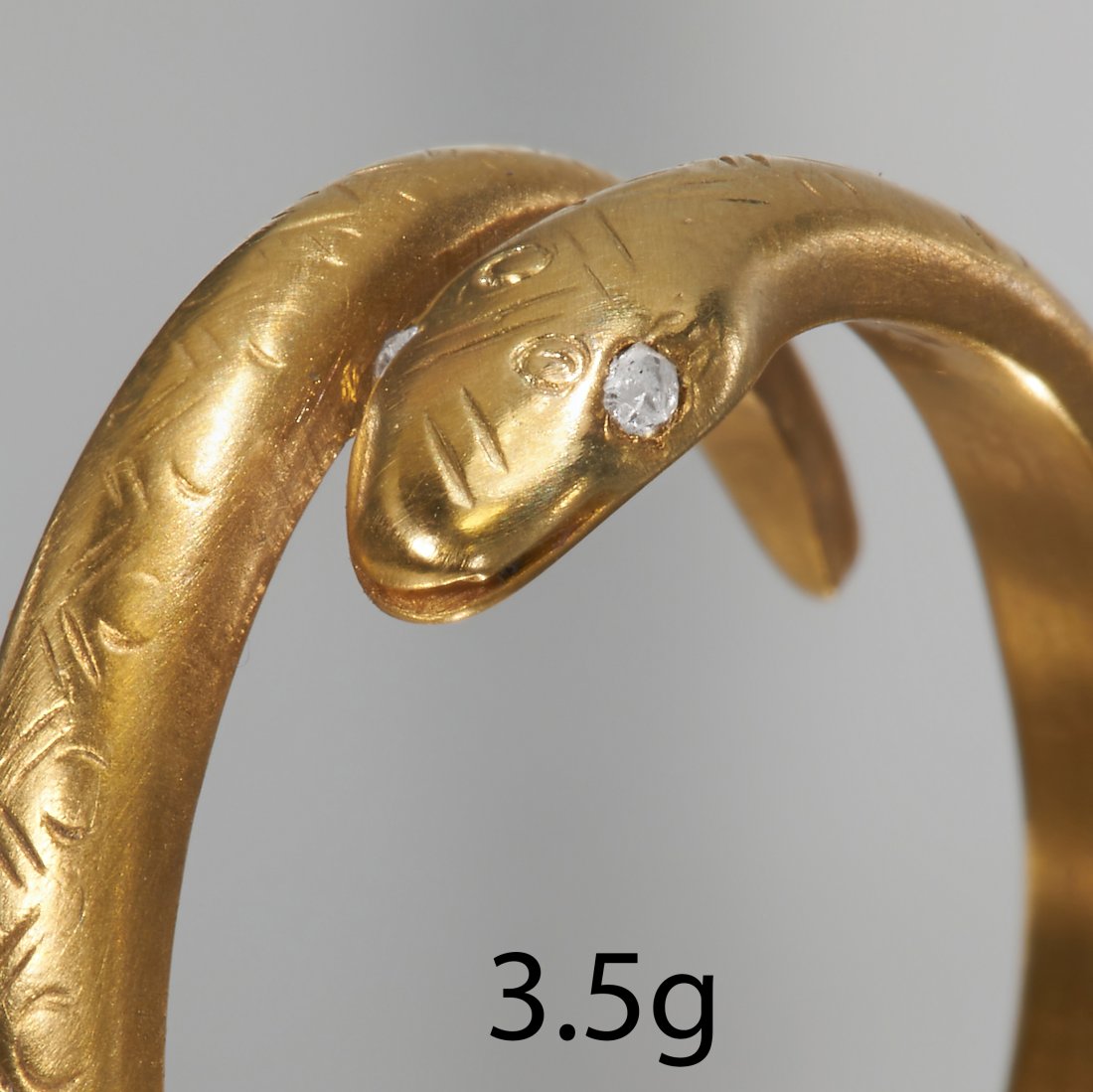 DIAMOND SNAKE RING: DIAMOND SNAKE RING,High carat gold.Diamonds bright and lively.Size O.3.5 grams.
