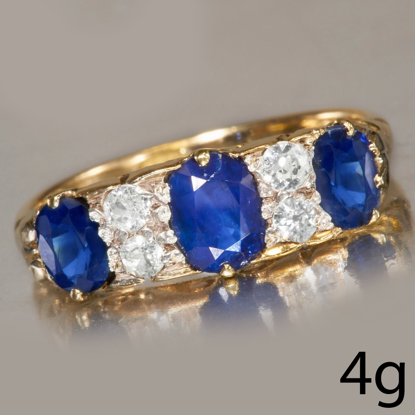 SAPPHIRE AND DIAMOND RING: SAPPHIRE AND DIAMOND RING,18 ct. gold.Gemstones totalling approx. 2.10 ct.Sapphires well matched, totalling approx. 1.85 ct.Diamonds bright and lively.Size O 1/2.4 grams.