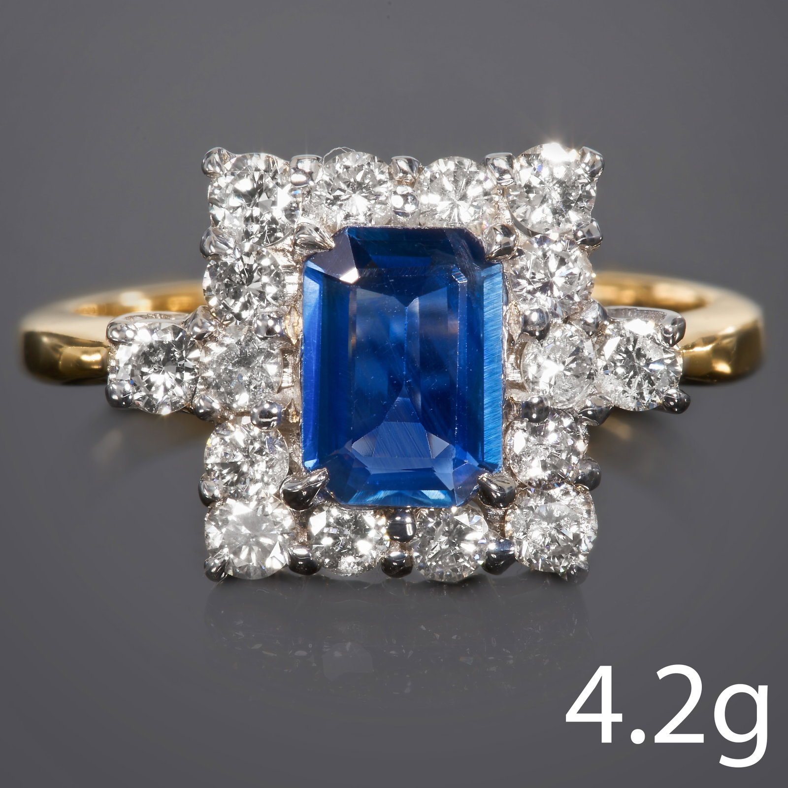 SAPPHIRE AND DIAMOND CLUSTER RING: SAPPHIRE AND DIAMOND CLUSTER RING.high carat gold.Gemstones totalling approx. 1.60 ct.vibrant sapphire with good claritydiamonds are bright, in our opinion I/SI.Size M.4.2 grams.