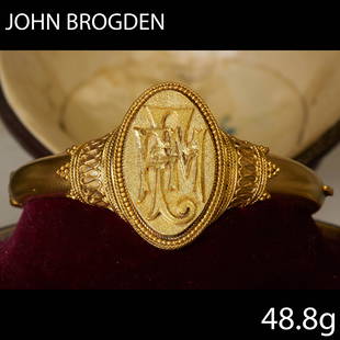 JOHN BROGDEN, VICTORIAN ETRUSCAN REVIVAL HINGED BANGLE: JOHN BROGDEN, VICTORIAN ETRUSCAN REVIVAL HINGED BANGLE,The marquise shaped center with initials.Inner diam. 5.4 cm.48.8 grams.With original John Brogden fitted case.