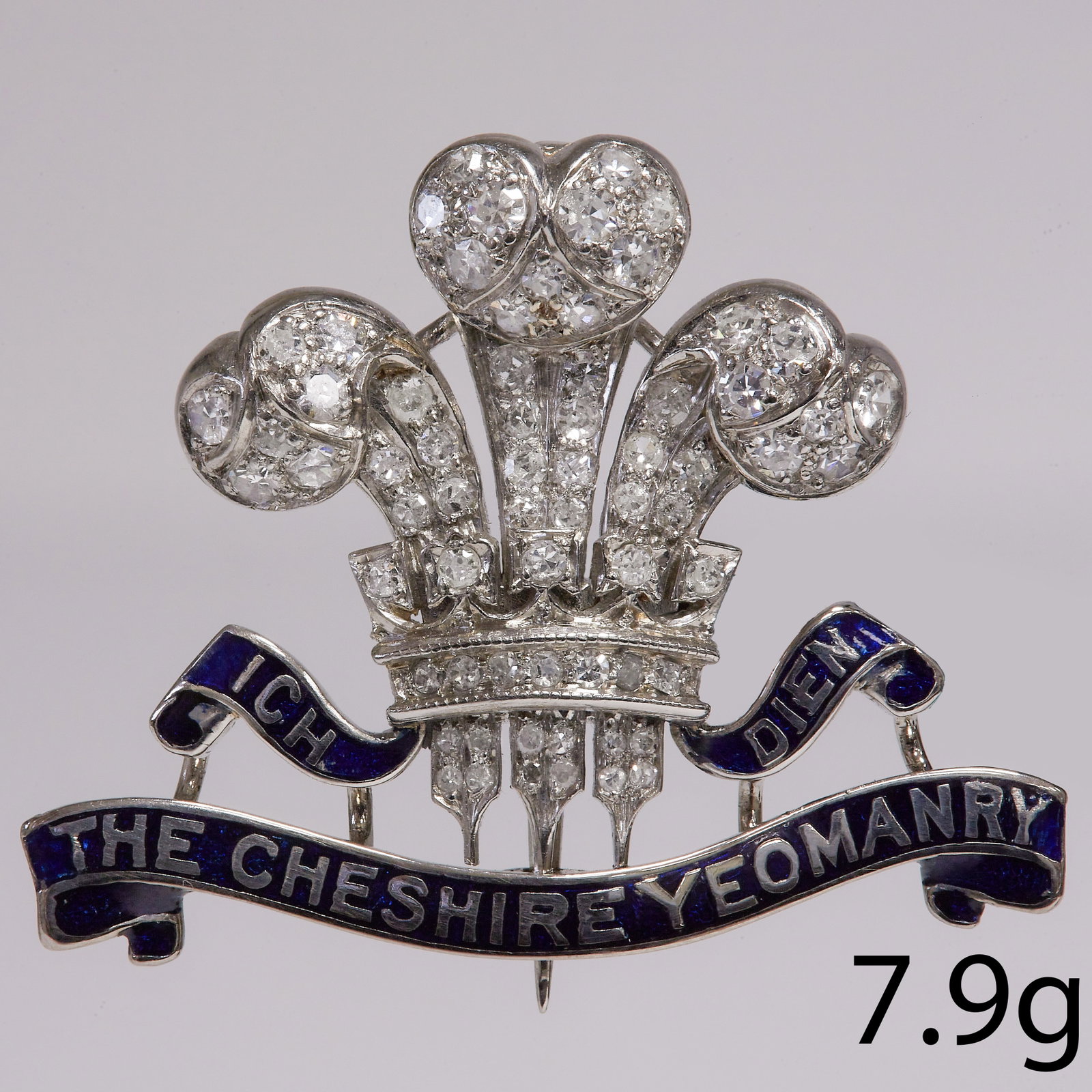 RARE DIAMOND AND ENAMEL REGIMENTAL BROOCH: RARE DIAMOND AND ENAMEL REGIMENTAL BROOCH,7.9 grams, High carat gold.Diamonds totalling approx. 1.10 ct. Diamonds G-h colour, VS/SI clarity.Underneath a ribbon with text and blue enamel: Ich Dien, The