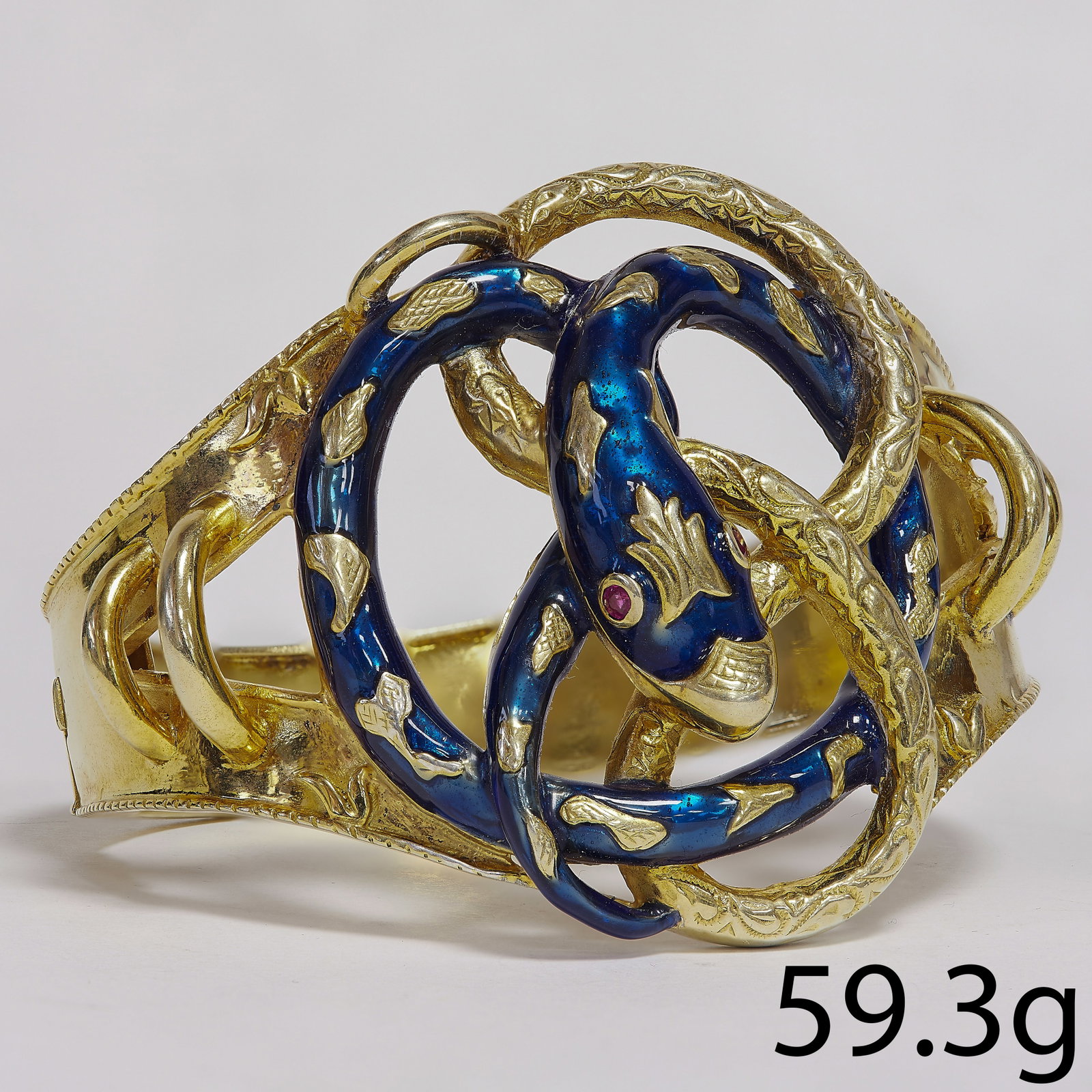 LOVELY ANTIQUE ENAMEL SNAKE HINGED BANGLE: LOVELY ANTIQUE ENAMEL SNAKE HINGED BANGLE,59.3 grams.The large wide center of the bangle with a snake with enamel.Ruby eyes.Inner diam. 6.1 cm. W. 5.5 cm.