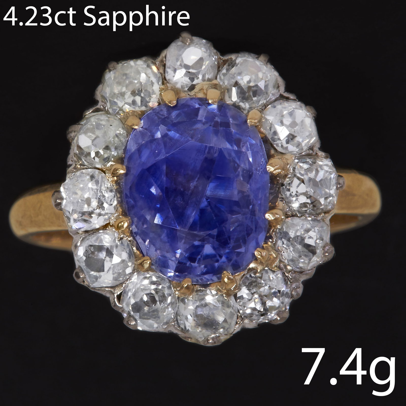 SAPPHIRE AND DIAMOND CLUSTER RING: SAPPHIRE AND DIAMOND CLUSTER RING.7.4 grams, 18 ct. gold.Set with vibrant sapphire 4.23 ct. approx.Bright and lively diamonds 1.20 ct. approx.Size: M