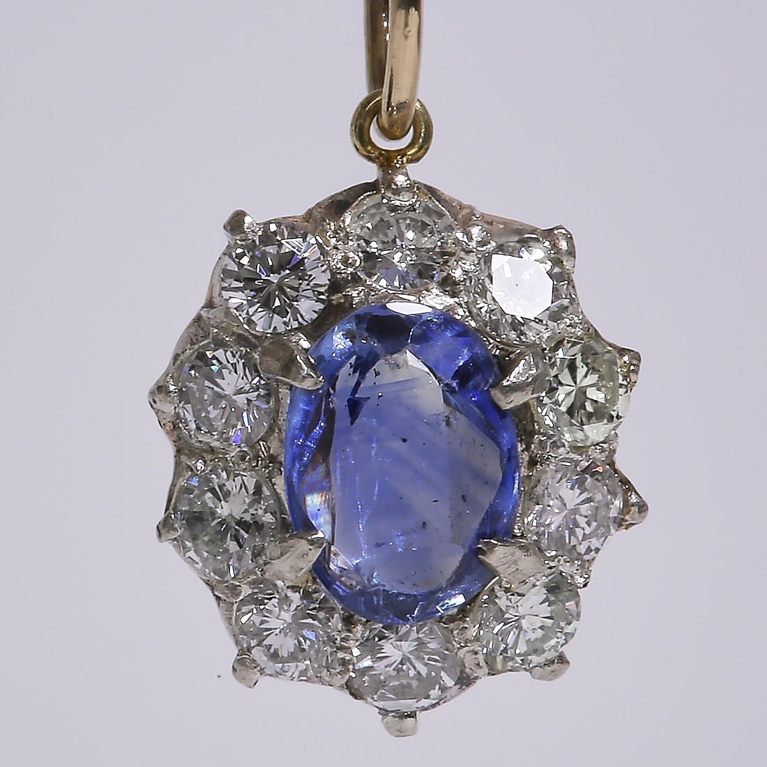 SAPPHIRE AND DIAMOND PENDANT: SAPPHIRE AND DIAMOND PENDANT,Vibrant sapphire.Gemstones totalling approx. 1.10 ct.