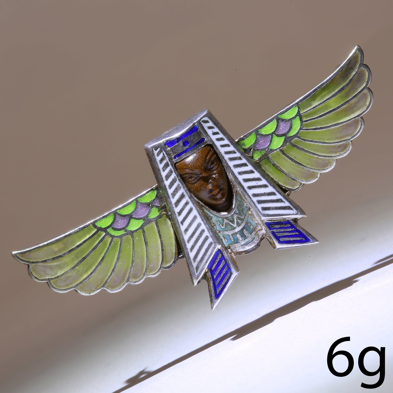 EGYPTIAN REVIVAL ENAMEL PHARAOH BROOCH: EGYPTIAN REVIVAL ENAMEL PHARAOH BROOCH,6 grams.The wings with plique a jour enamel.W. 4.6 cm.
