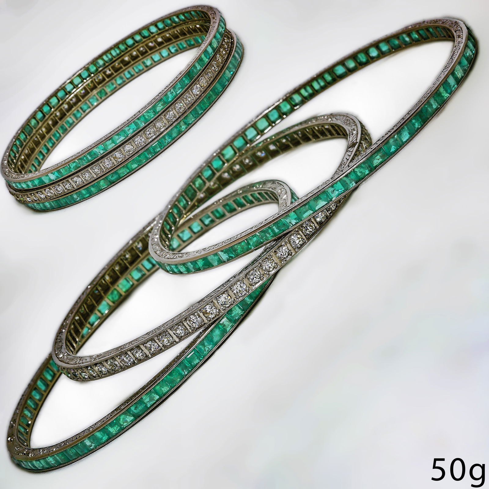 EXQUISITE SET OF 3 ART-DECO EMERALD AND DIAMOND BANGLES