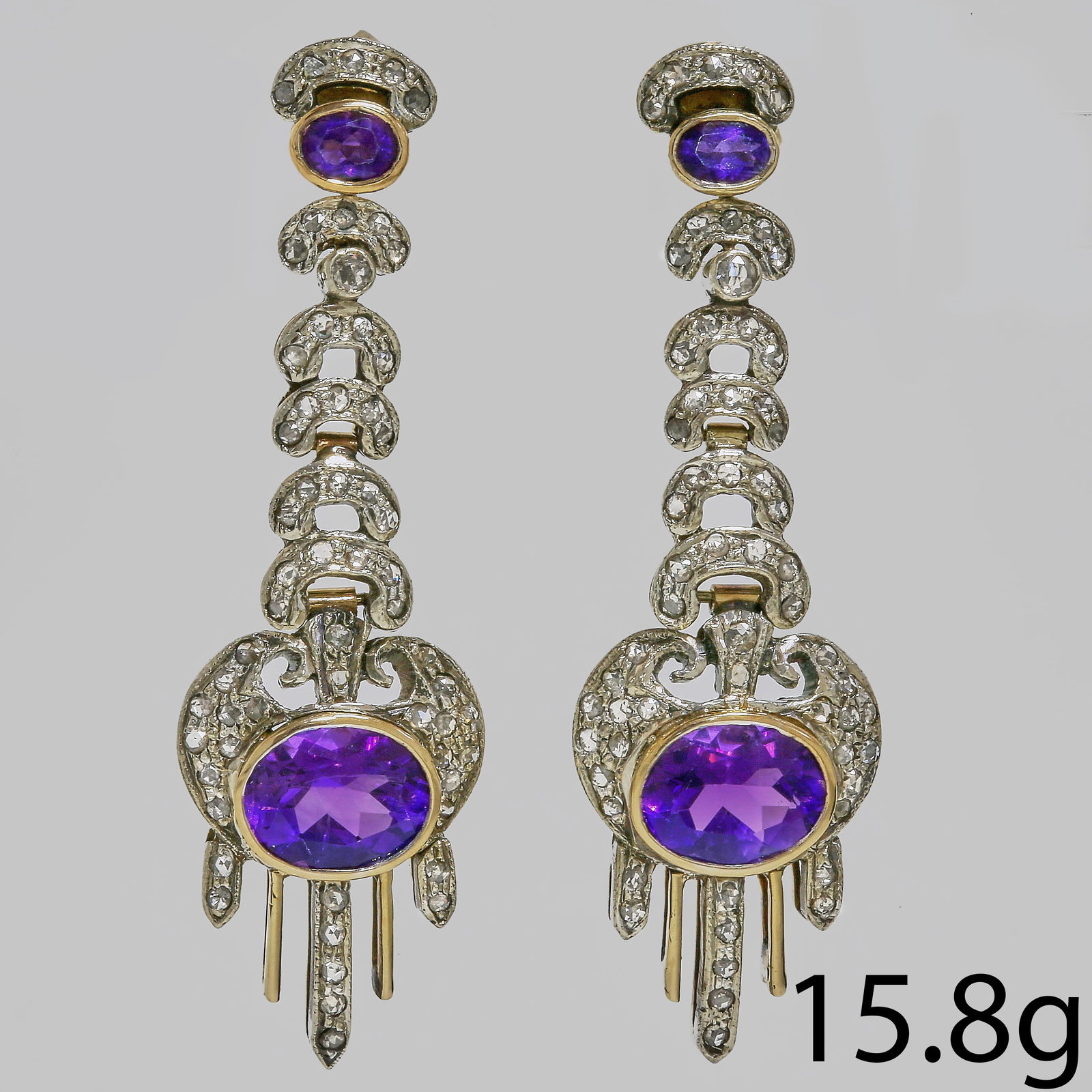 PAIR OF AMETHYST AND DIAMOND EARRINGS: PAIR OF AMETHYST AND DIAMOND EARRINGS,15.8 grams.Diamonds bright and lively.Rich and vibrant amethyst.Articulated.L. 5.4 cm.
