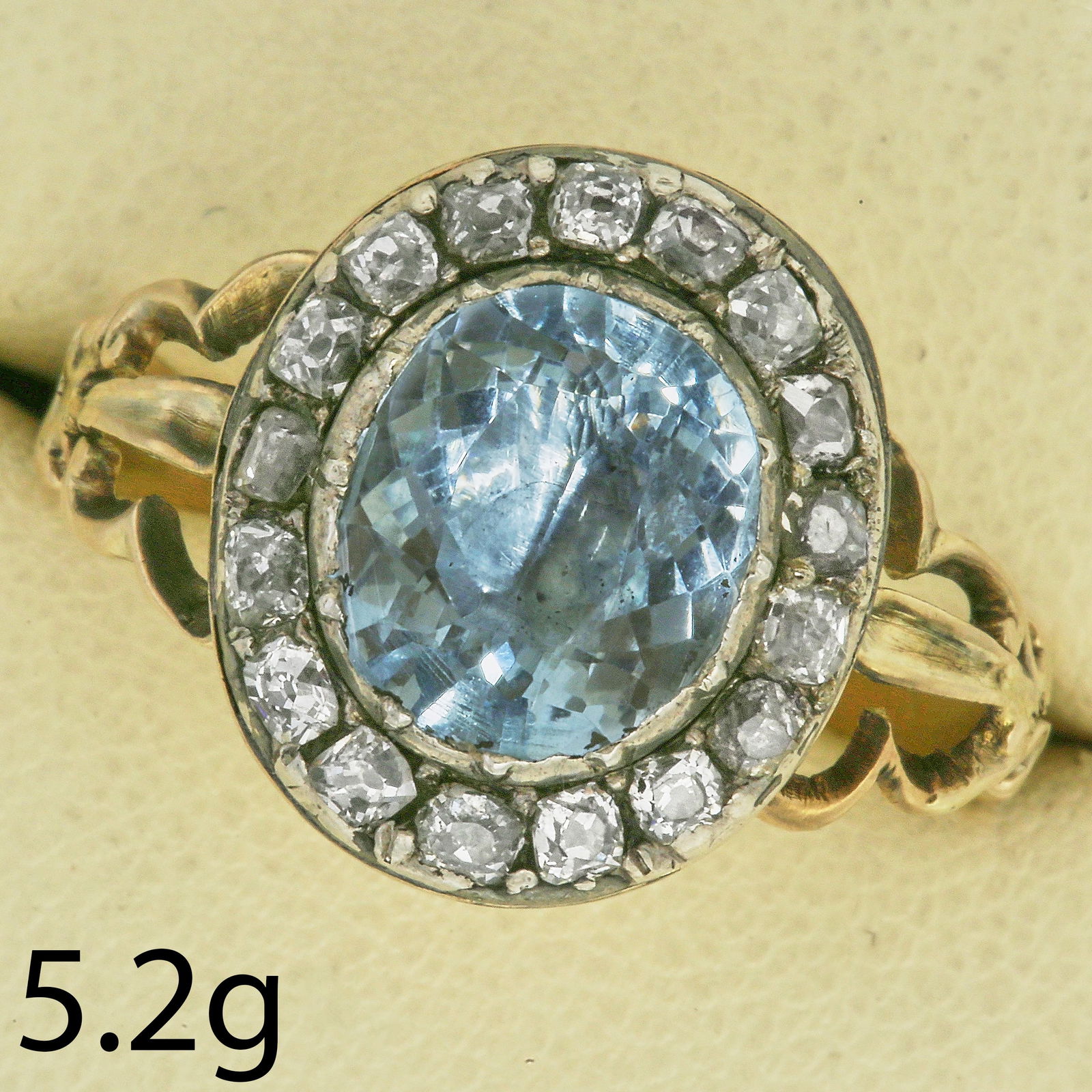 ANTIQUE AQUAMARINE AND DIAMOND CLUSTER RING: ANTIQUE AQUAMARINE AND DIAMOND CLUSTER RING,5.2 grams.Vibrant aquamarine of approx. 2.85 ct.Domed back.Size R.
