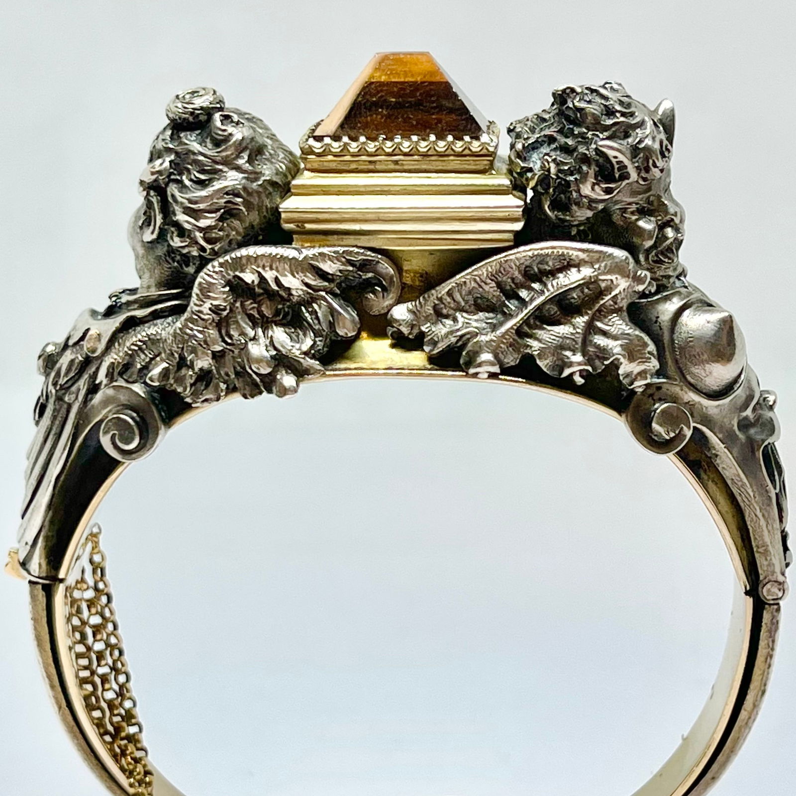 FROMENT MEURICE (attrib.) CITRINE CHERUB BANGLE: FROMENT MEURICE (attrib.) CITRINE CHERUB BANGLE,78.1 grams, testing high cart gold and silver.The design flanked by two opposing winged figures, modelled in deeply chased silver with strong sculptural