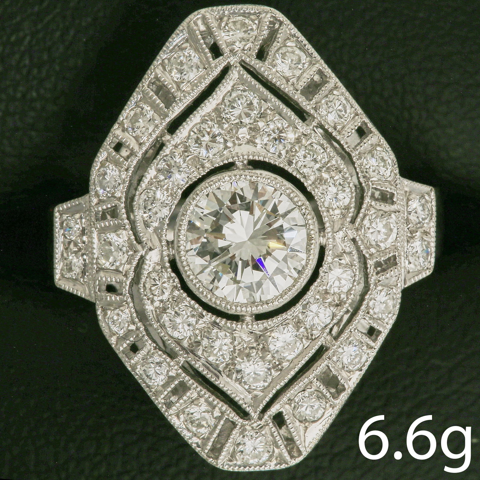 ART-DECO DESIGN DIAMOND RING: ART-DECO DESIGN DIAMOND RING,6,6 grams, testing 18 ct. gold.Larger central diamond.Diamonds totalling approx. 1.65 ct.L. head 2.1 cm.Size L.