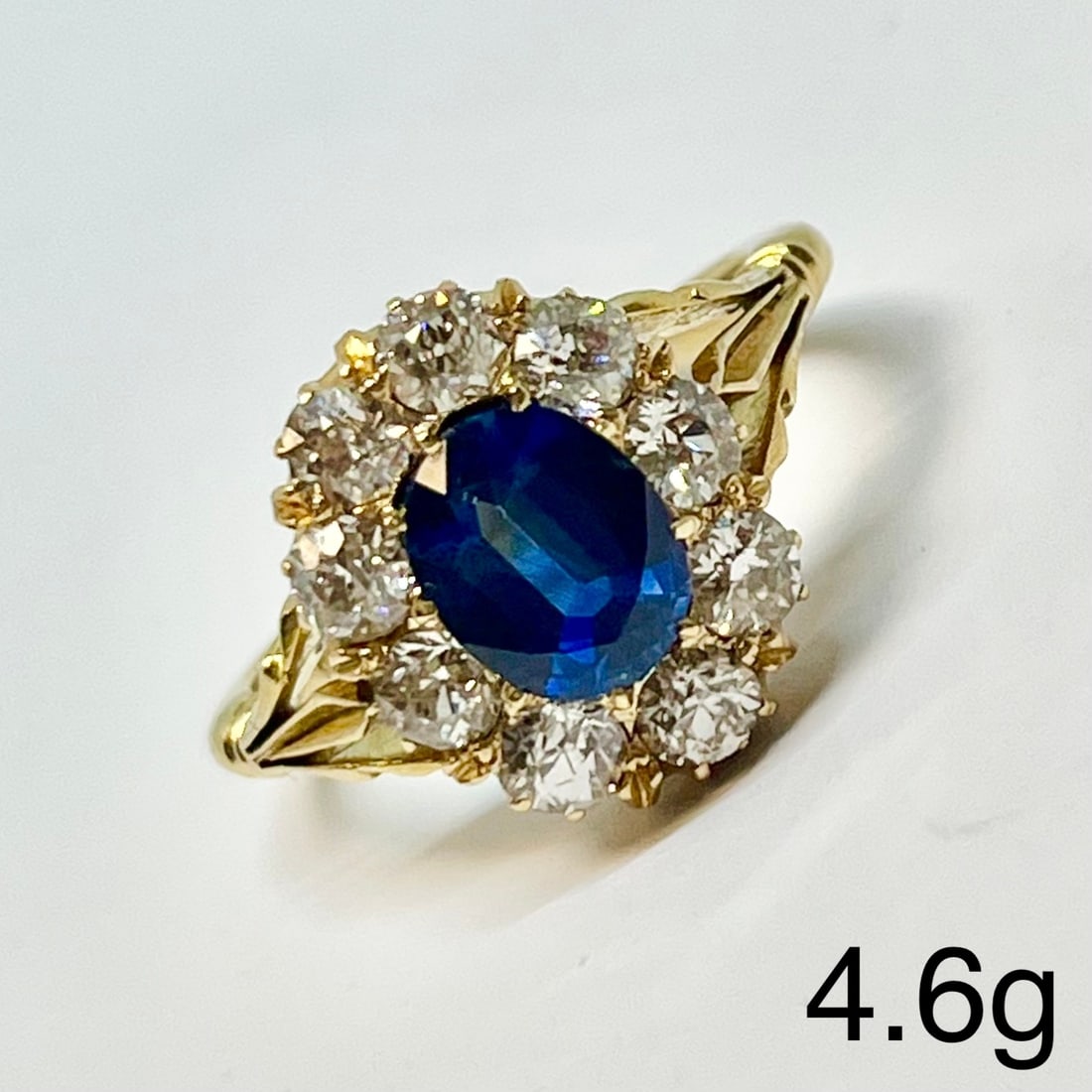 SAPPHIRE AND DIAMOND CLUSTER RING: SAPPHIRE AND DIAMOND CLUSTER RING,4,6 grams, testing high carat gold.Rich and vibrant sapphire of approx. 1.52 ct.Diamonds bright and lively, totalling approx. 0.90 ct.Size M 1/2.