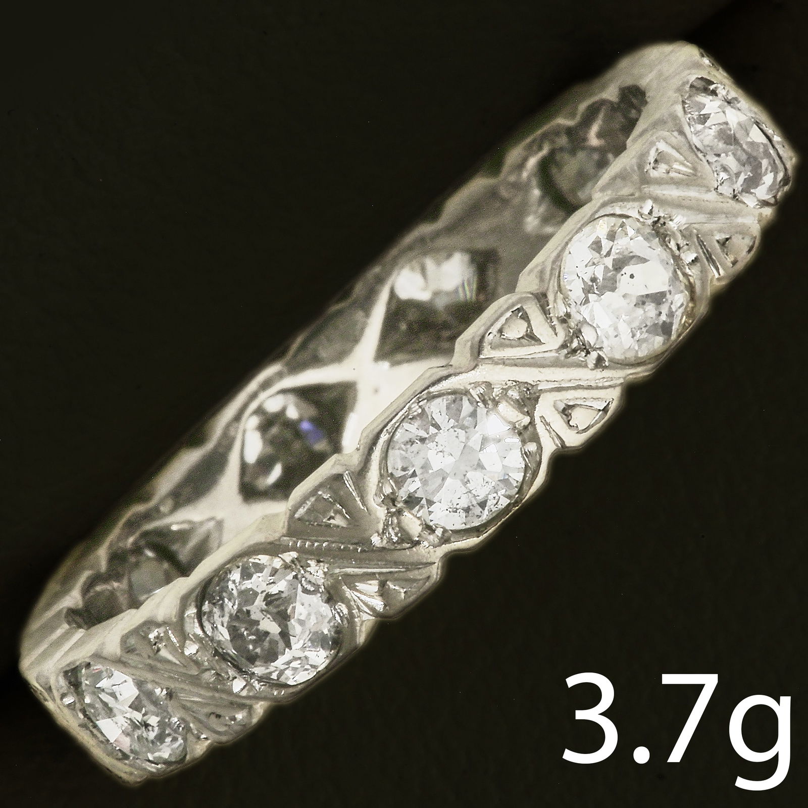 DIAMOND ETERNITY RING: DIAMOND ETERNITY RING,3.7 grams, testing high carat gold.Diamonds bright and lively, totalling approx. 1.20 ct.Size N.