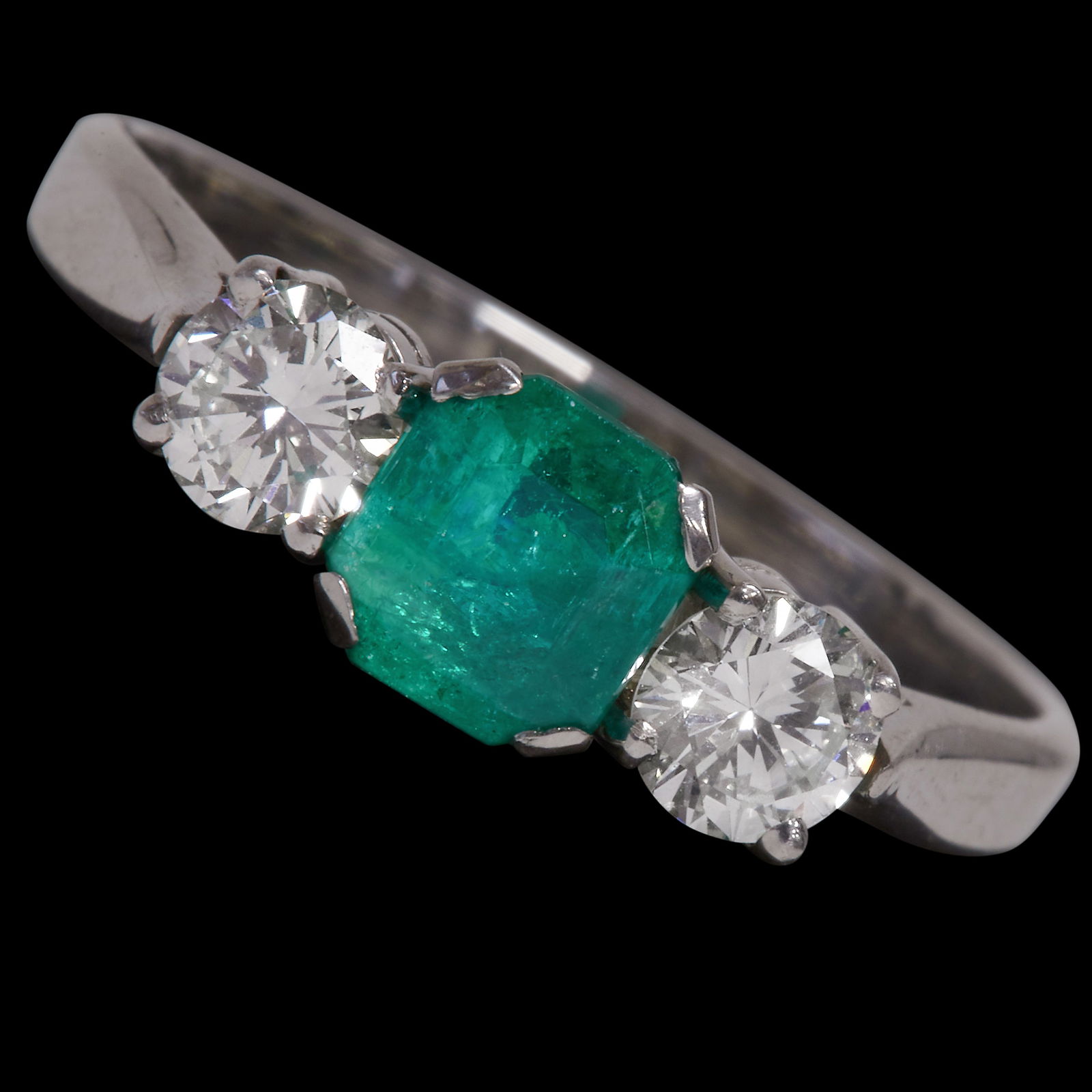 EMERALD AND DIAMOND 3 STONE RING: EMERALD AND DIAMOND 3 STONE RING,18 ct. gold.Gemstones totalling approx. 1.40 ct.Size O 1/2.