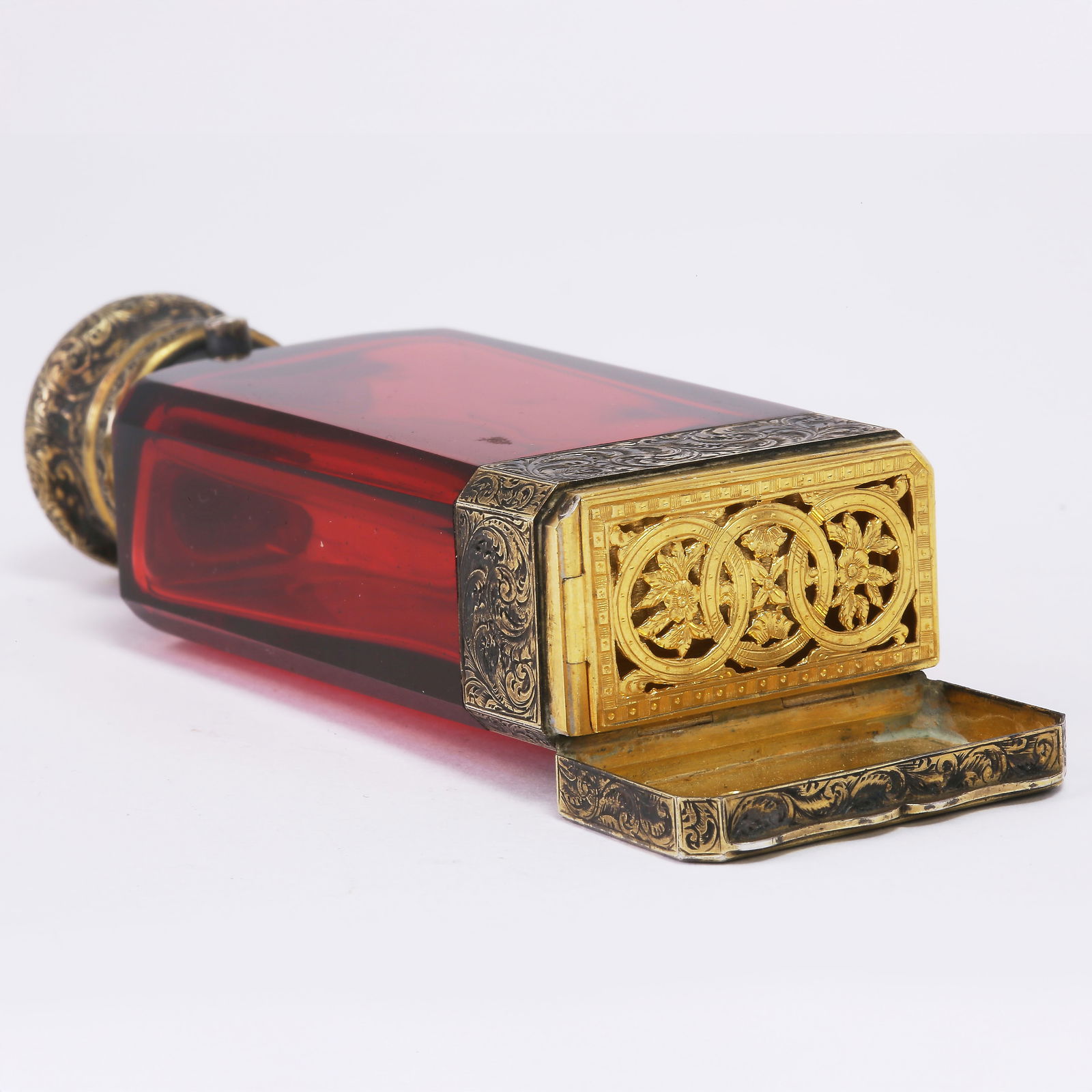 S. MORDAN AND CO. RARE RUBY GLASS PERFUME BOTTLE WITH VINAIGRETTE: S. MORDAN AND CO. RARE RUBY GLASS PERFUME BOTTLE WITH VINAIGRETTE,117.7 grams.A highly unusual and finely executed Victorian ruby glass perfume bottle. The faceted ruby glass body is of strong, even c