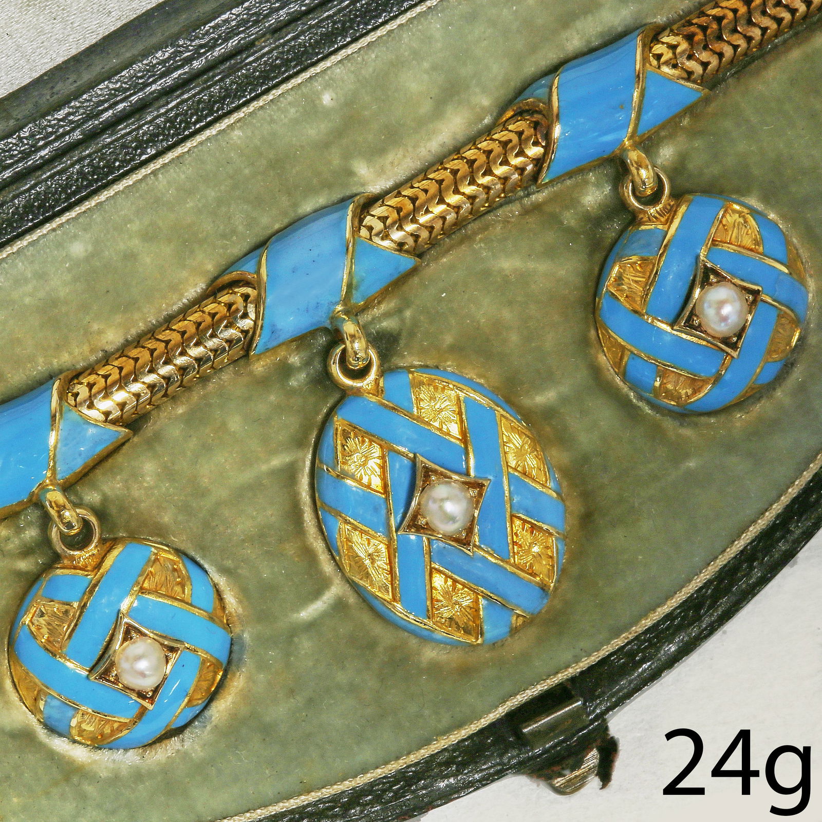EARLY VICTORIAN TURQUOISE ENAMEL AND PEARL BRACELET: EARLY VICTORIAN TURQUOISE ENAMEL AND PEARL BRACELET,24 grams, testing high carat gold.The 3 drops each with fine turquoise coloured enamel in cross entwined pattern, set with a pearl. Each drop with