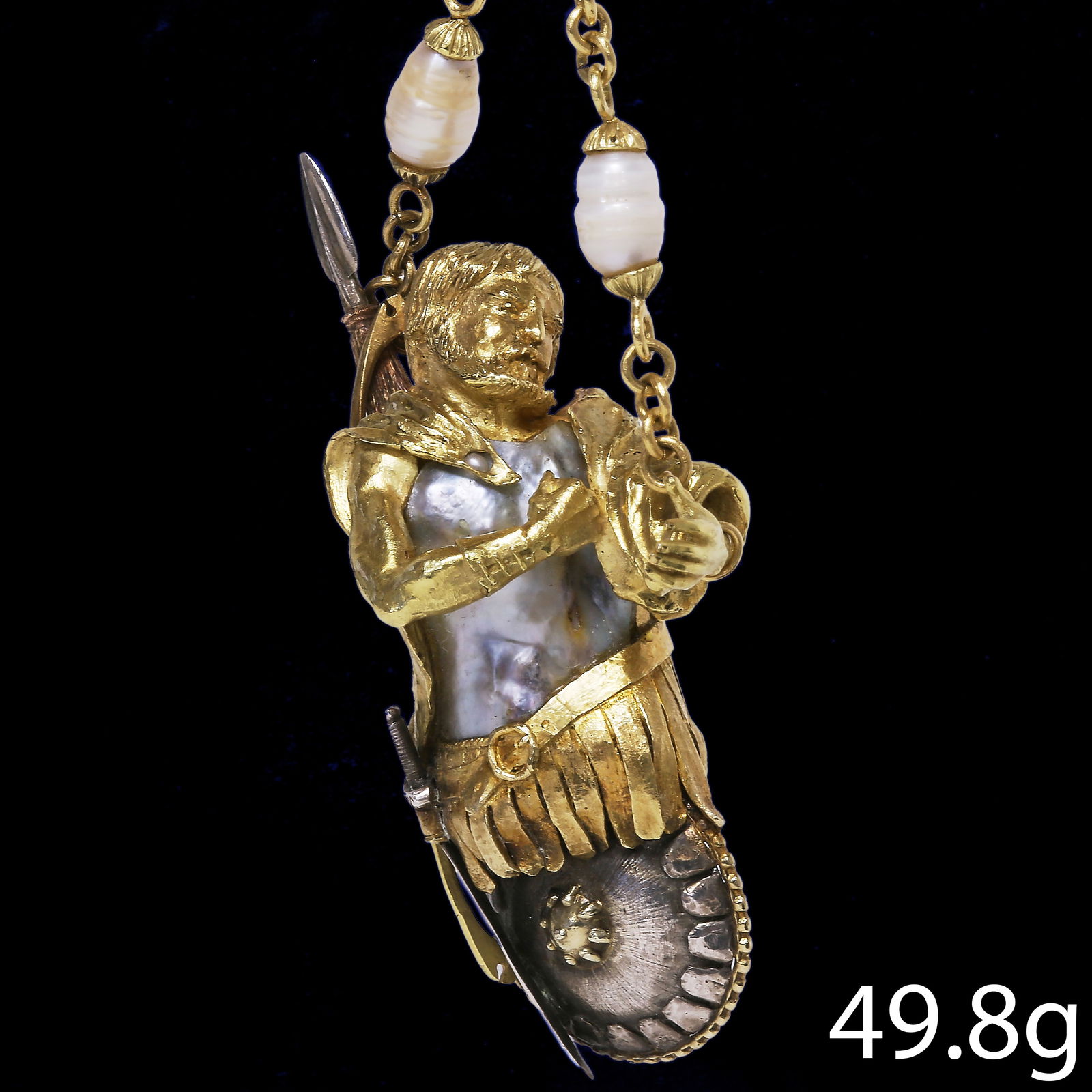 RARE ANTIQUE PEARL WARRIOR PENDANT: RARE ANTIQUE PEARL WARRIOR PENDANT,49.8 grams, 18 ct. gold and silver.The body set with a large pearl (assumed to be natural).Intricate designed as a roman warrior.Suspending from a pearl set chain
