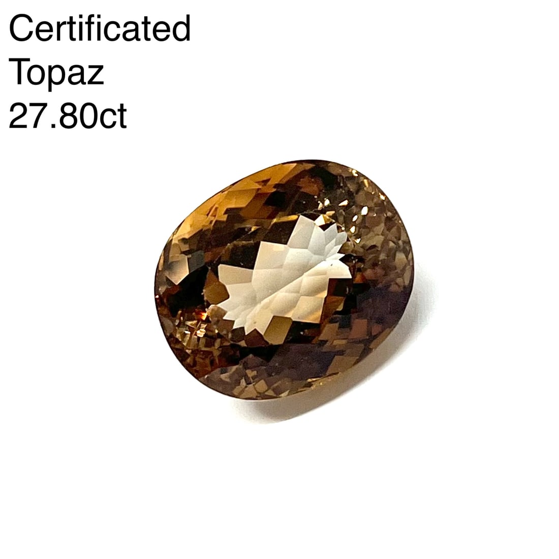 CERTIFICATED LARGE FANCY TOPAZ OF 27,82 CT: CERTIFICATED LARGE FANCY TOPAZ OF 27,82 CT.The topal of oval mixed cut of 27,82 ct.17,88 x 14,91 x 11,92 mm.See certificate