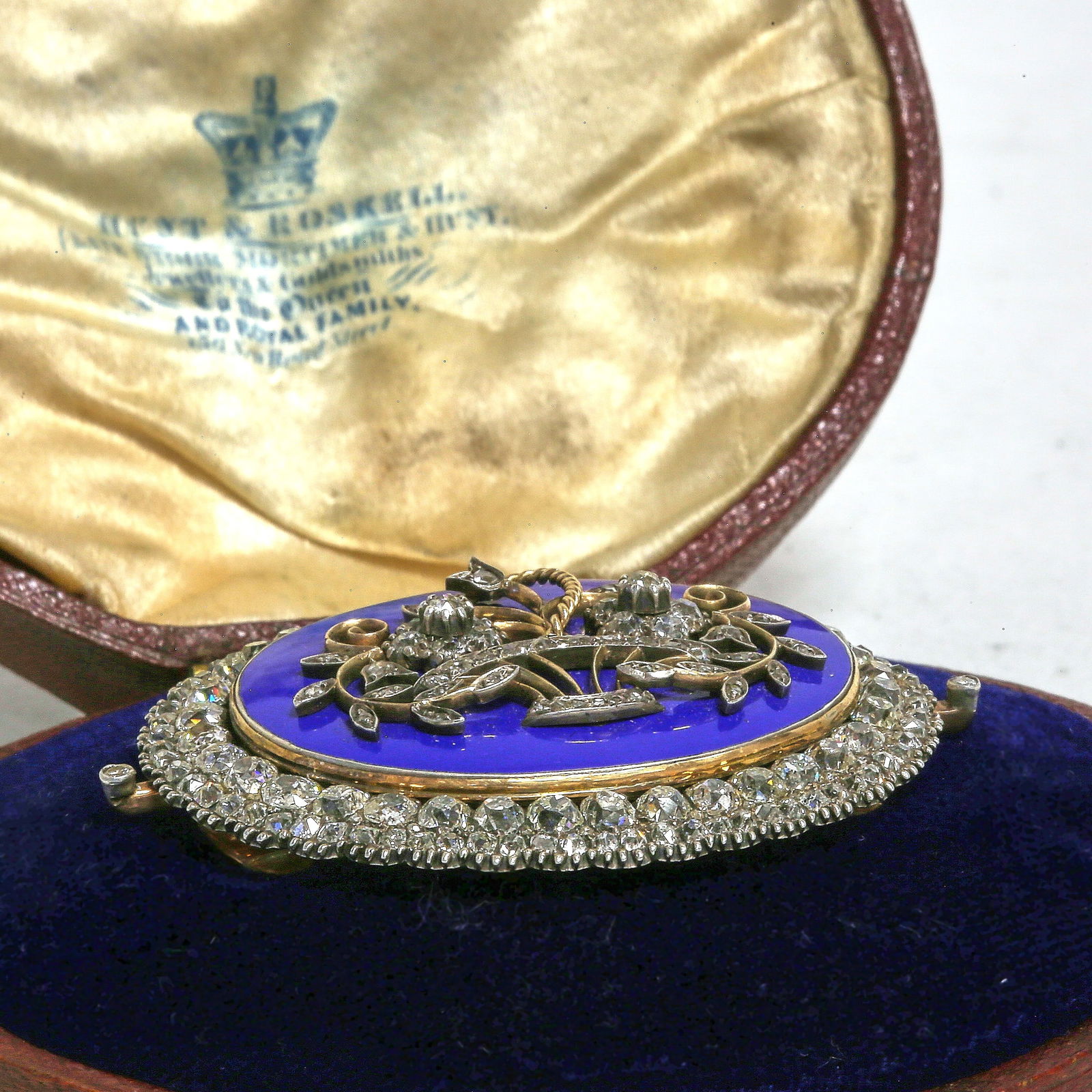 RARE LARGE GEORGIAN DIAMOND AND ENAMEL BROOCH: RARE LARGE GEORGIAN DIAMOND AND ENAMEL BROOCH,32.8 grams, high carat gold.The blue enamel centre with floral diamond set applique.In a double row surround with old cut diamonds.Diamonds totalling appr