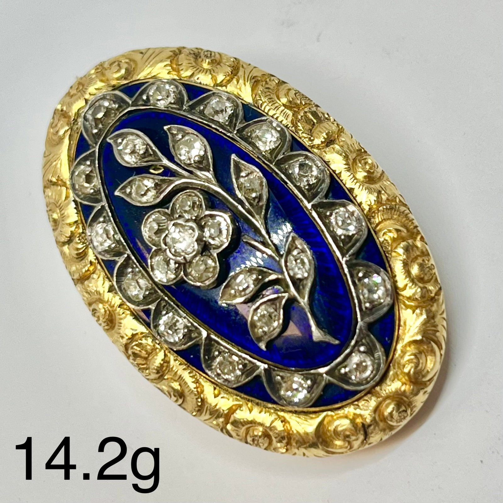 GEORGIAN DIAMOND LOCKET BACK BROOCH: GEORGIAN DIAMOND LOCKET BACK BROOCH,14.2 grams, testing high carat gold.Diamonds bright and lively, with a diamond set flower to the centre and further diamond border.Locket back, with text and dated.