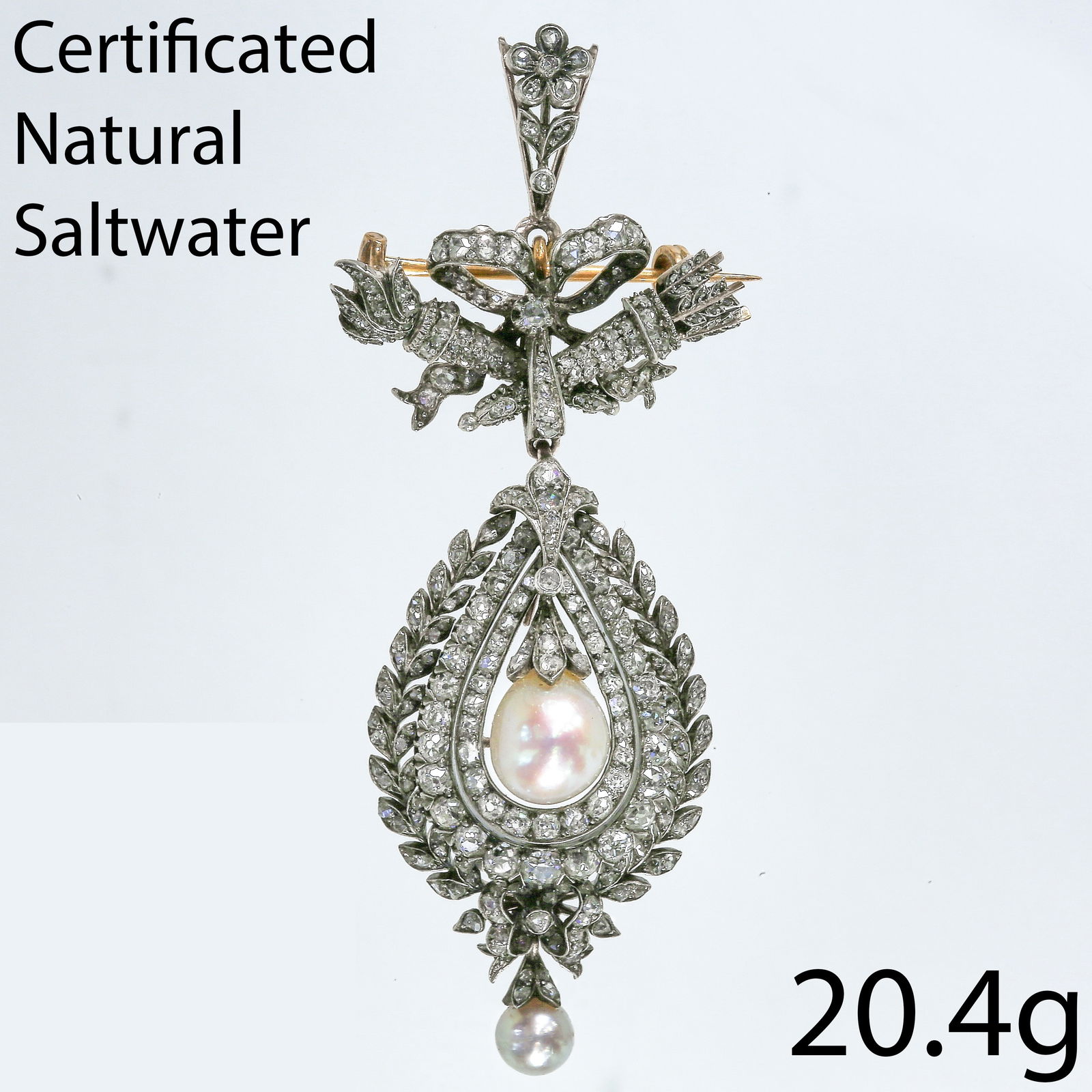 A MAGNIFICENT VICTORIAN CERTIFICATED NATURAL SALTWATER PEARL AND DIAMOND BROOCH: A MAGNIFICENT VICTORIAN CERTIFICATED NATURAL SALTWATER PEARL AND DIAMOND BROOCH20.4 grams natural saltwater pearl and diamond brooch, exquisitely designed as a ribbon-tied floral spray suspending a pe