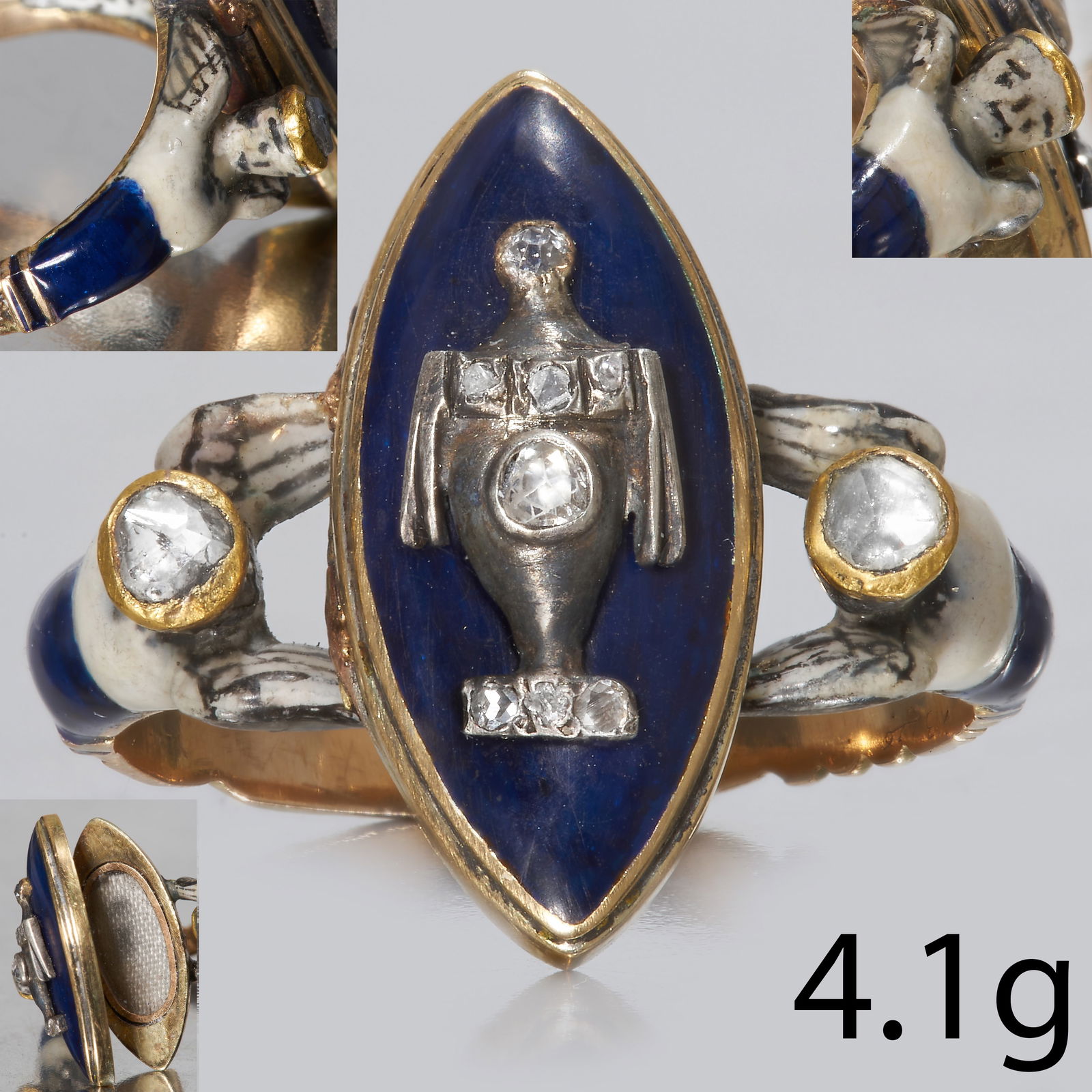 RARE ANTIQUE GEORGIAN ENAMEL AND DIAMOND LOCKET RING: RARE ANTIQUE GEORGIAN ENAMEL AND DIAMOND LOCKET RING,4.1 grams, testing 18 ct. gold.The marquise shaped top Set with a diamond set vase on a blue enamel background.The shoulders depicting angels, with