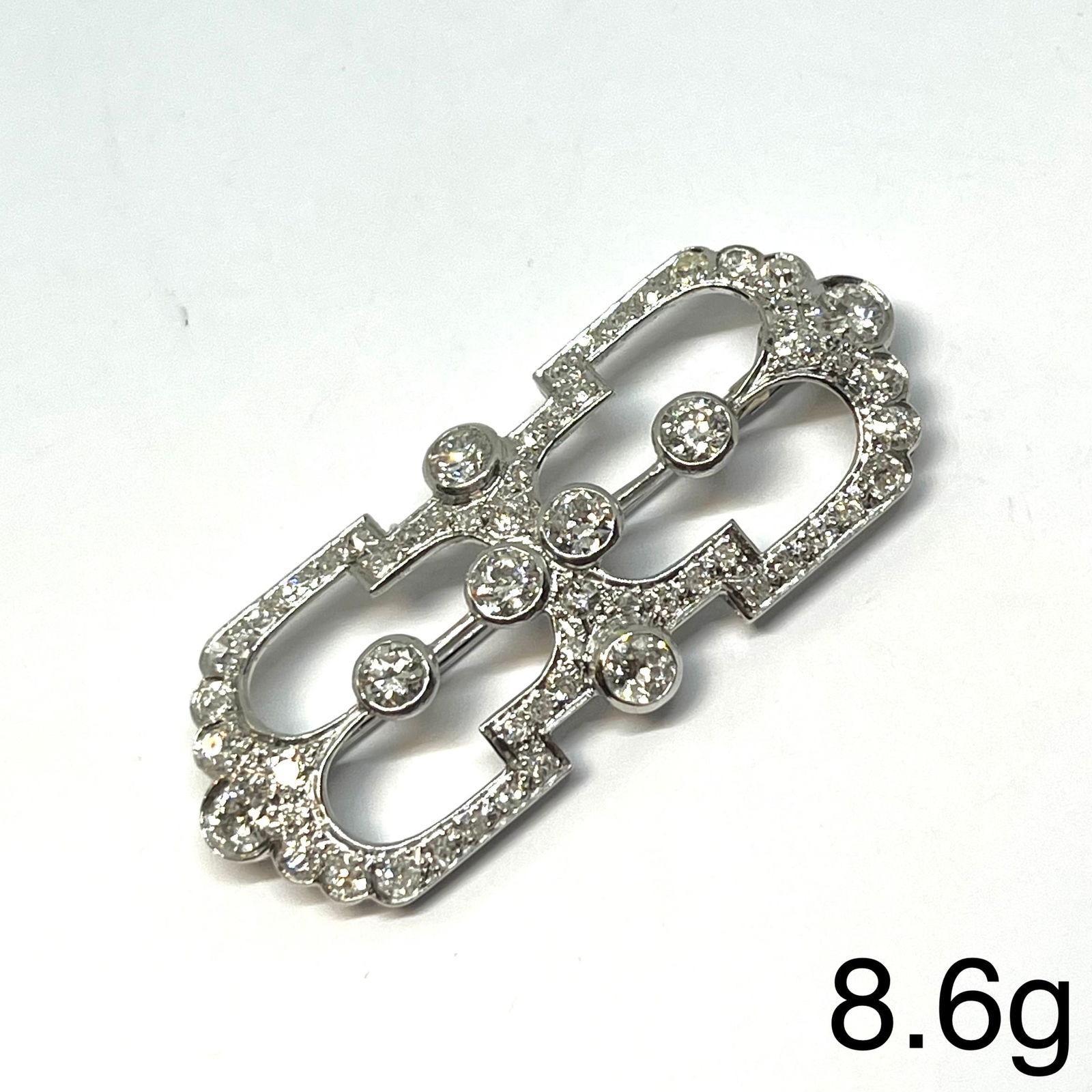 ART-DECO DIAMOND BROOCH: ART-DECO DIAMOND BROOCH,8.6 grams, testing high carat gold.Diamonds bright and lively, totalling approx. 2.15 ct.W. 4.6 cm.