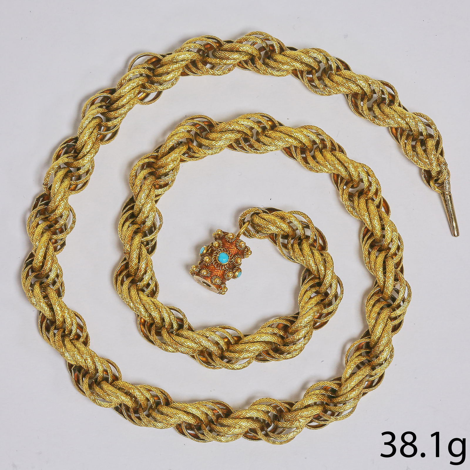 RARE GEORGIAN FANCY ROPE LINK NECKLACE WITH TURQUOISE BARREL CLASP: RARE GEORGIAN FANCY ROPE LINK NECKLACE WITH TURQUOISE BARREL CLASP,38.1 grams, testing high carat gold.The fancy links all with fine relief textured design.L.47 cm.